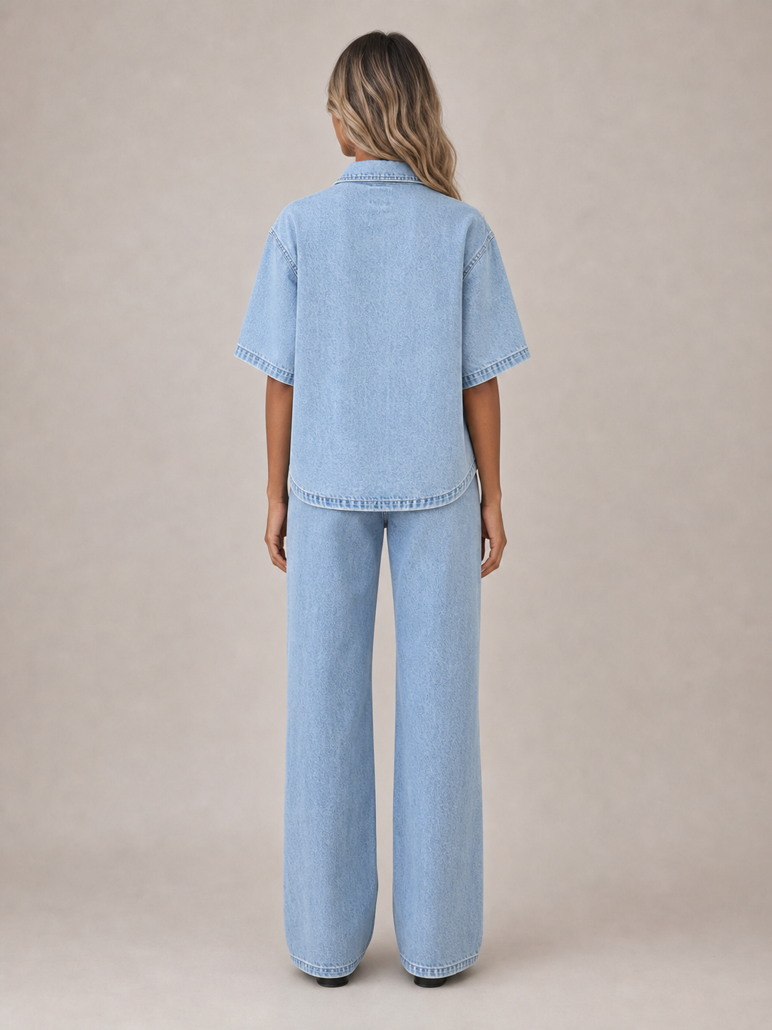 Back view of women's light wash short-sleeve denim shirt and straight jeans set