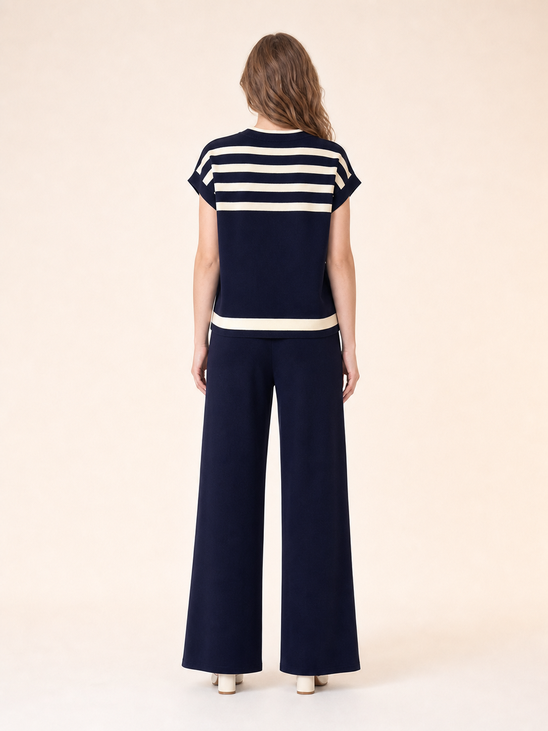 Back view of women's light wash short-sleeve denim shirt and straight jeans set