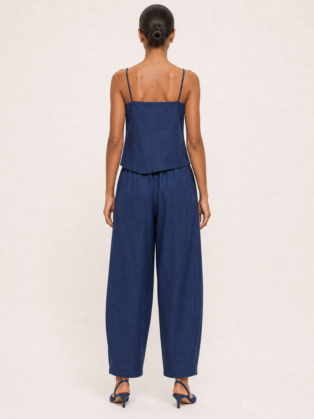 Women's navy asymmetric button camisole and tapered pants set back view