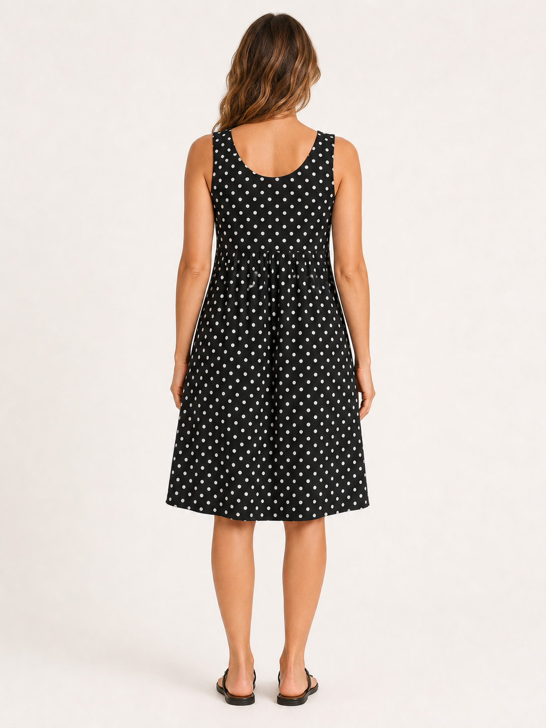 Women's black and white polka dot empire-waist swing dress back view