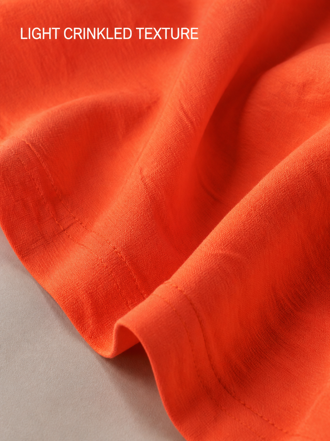 Light crinkled coral orange fabric texture detail