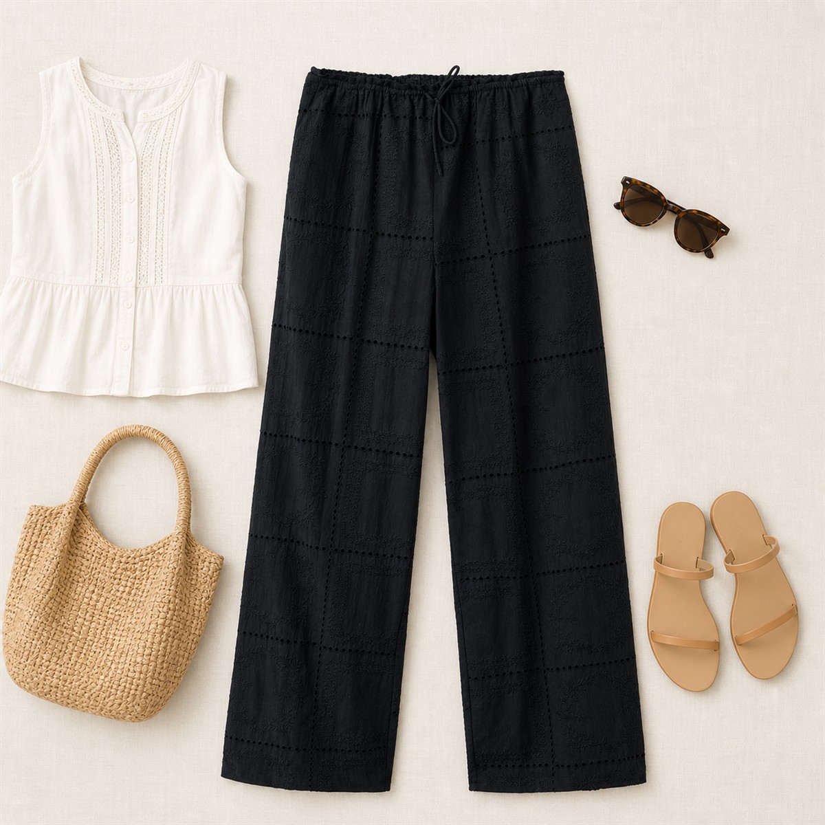 Tenue estivale claire autour du pantalon noir brodé