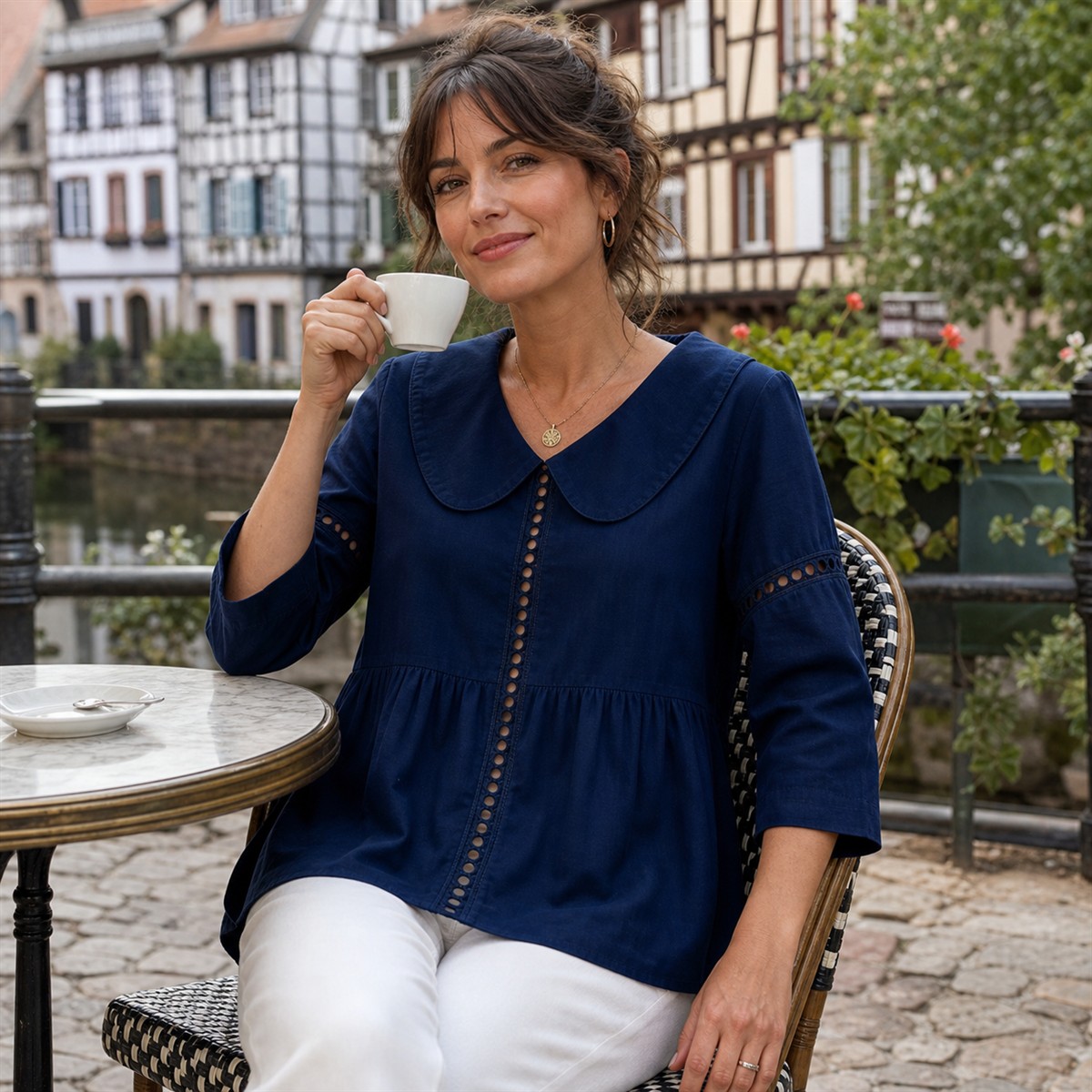 Femme portant la chemise bleu marine à une terrasse calme de Strasbourg