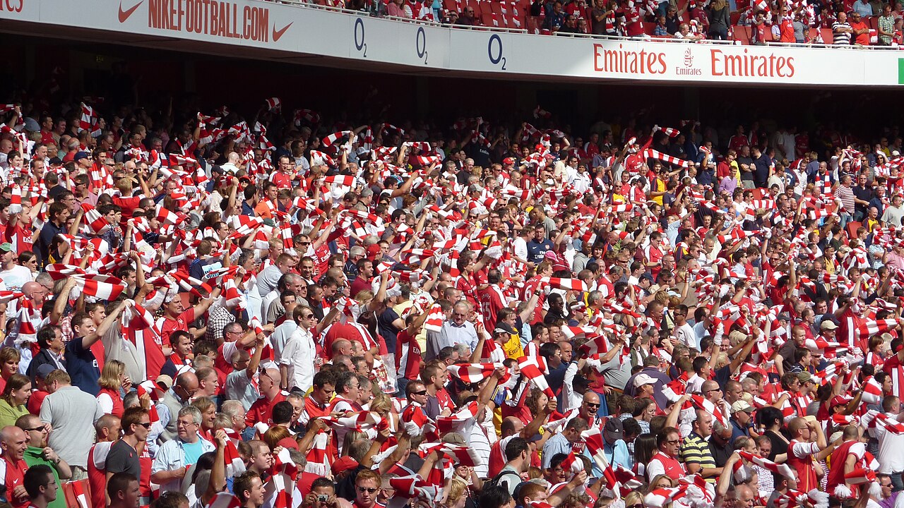 Arsenal supporters celebrating - fans wearing Arsenal shirts around the world