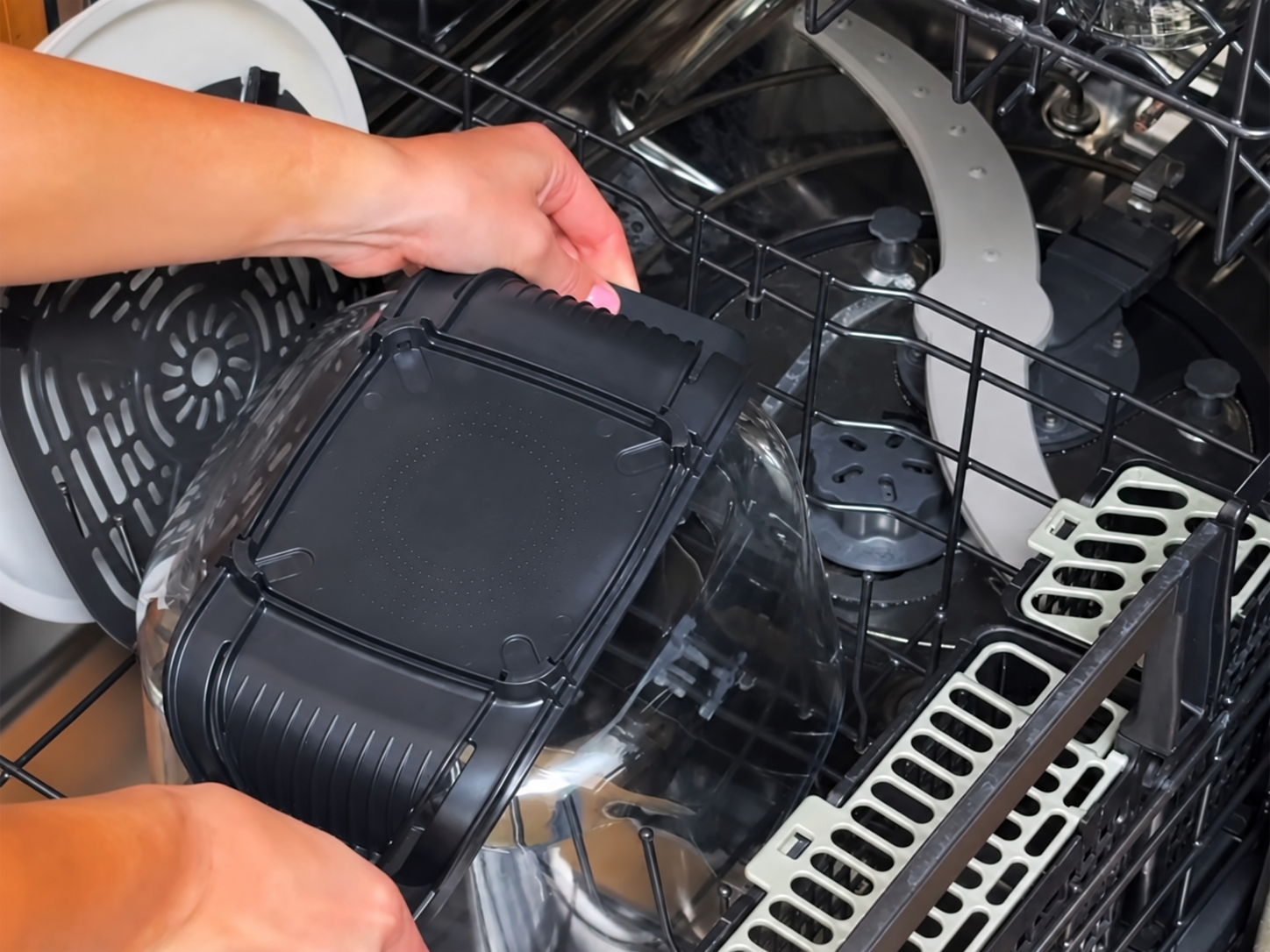 Glass cooking container being loaded into a dishwasher