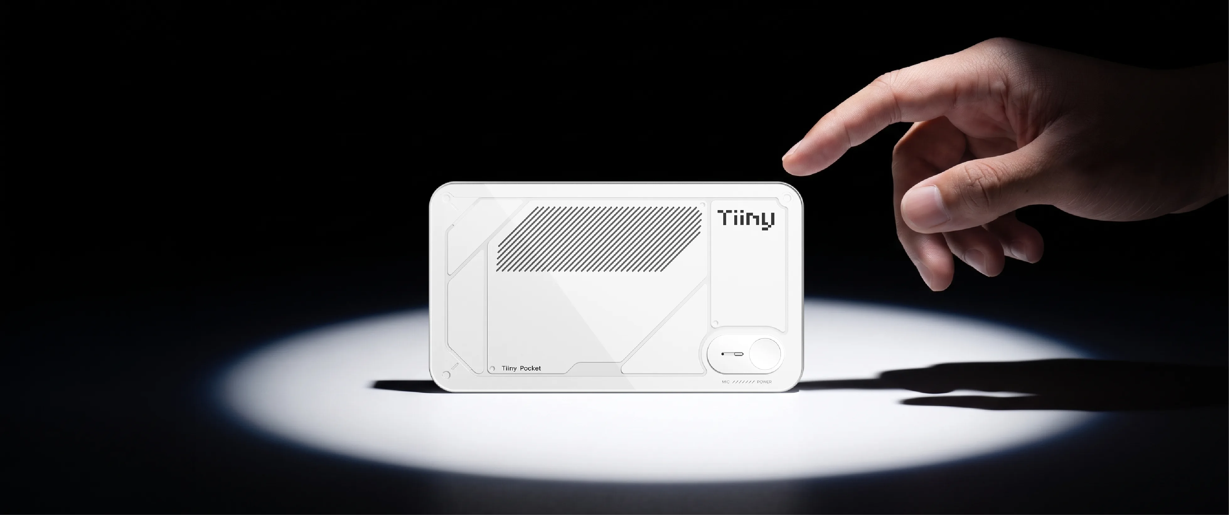 A hand reaching toward the white Tiiny Pocket device