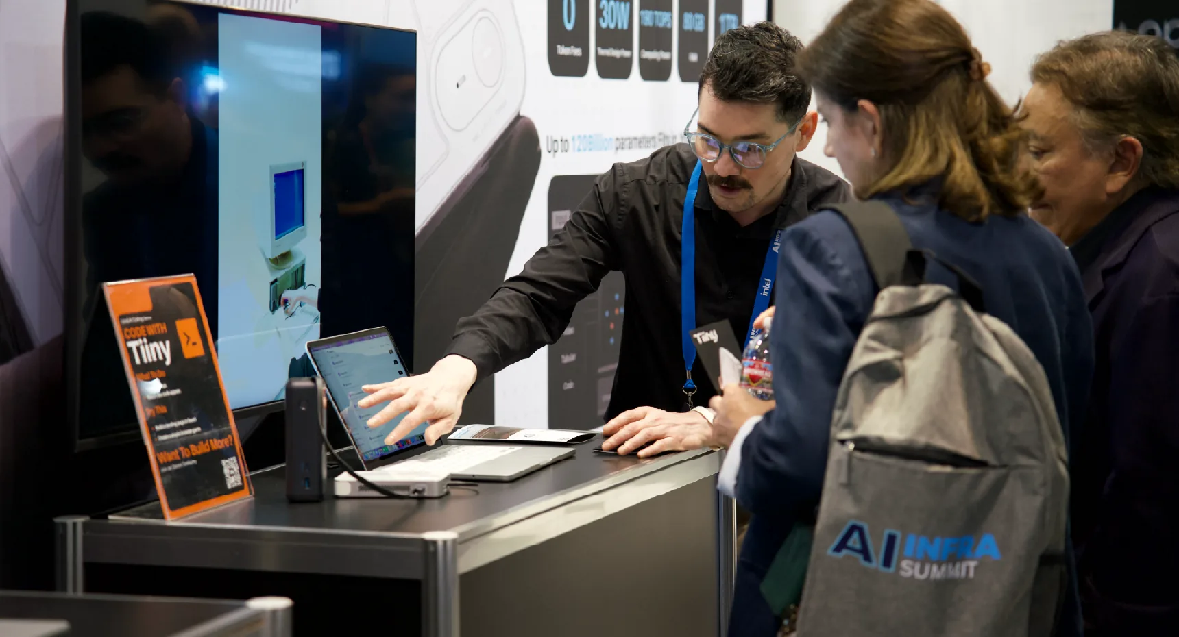 Visitors viewing a Tiiny Pocket demonstration at AI Infra Summit
