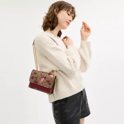 Mini Klare Crossbody Bag In Signature Canvas With Cherry Print