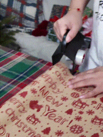 2 in 1 gift wrapping paper cutter and tape dispenser in use