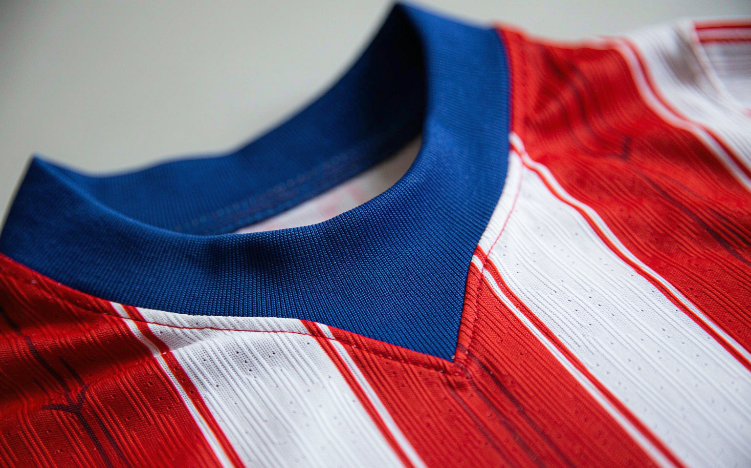 Close-up of football shirt fabric showing knit weave and collar detail