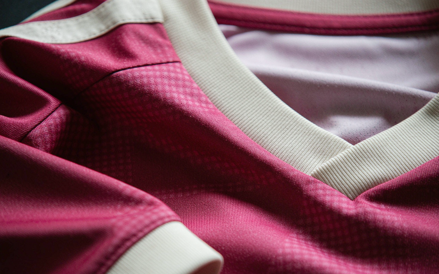 Close-up of football shirt fabric showing knit weave and collar detail