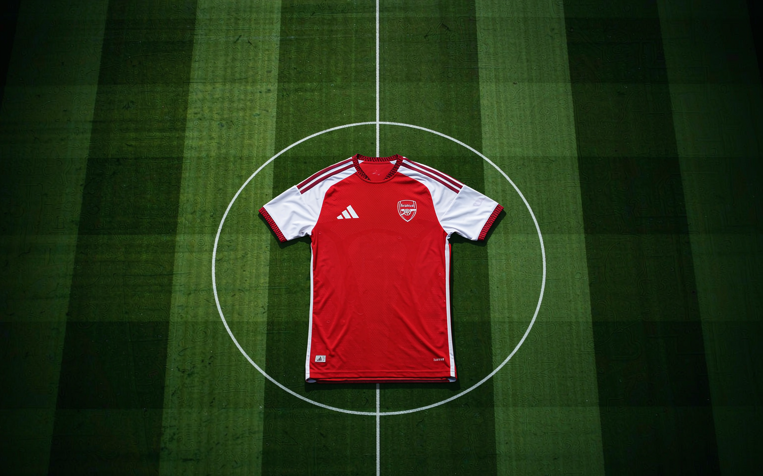 Top-down view of a floodlit pitch with white line markings