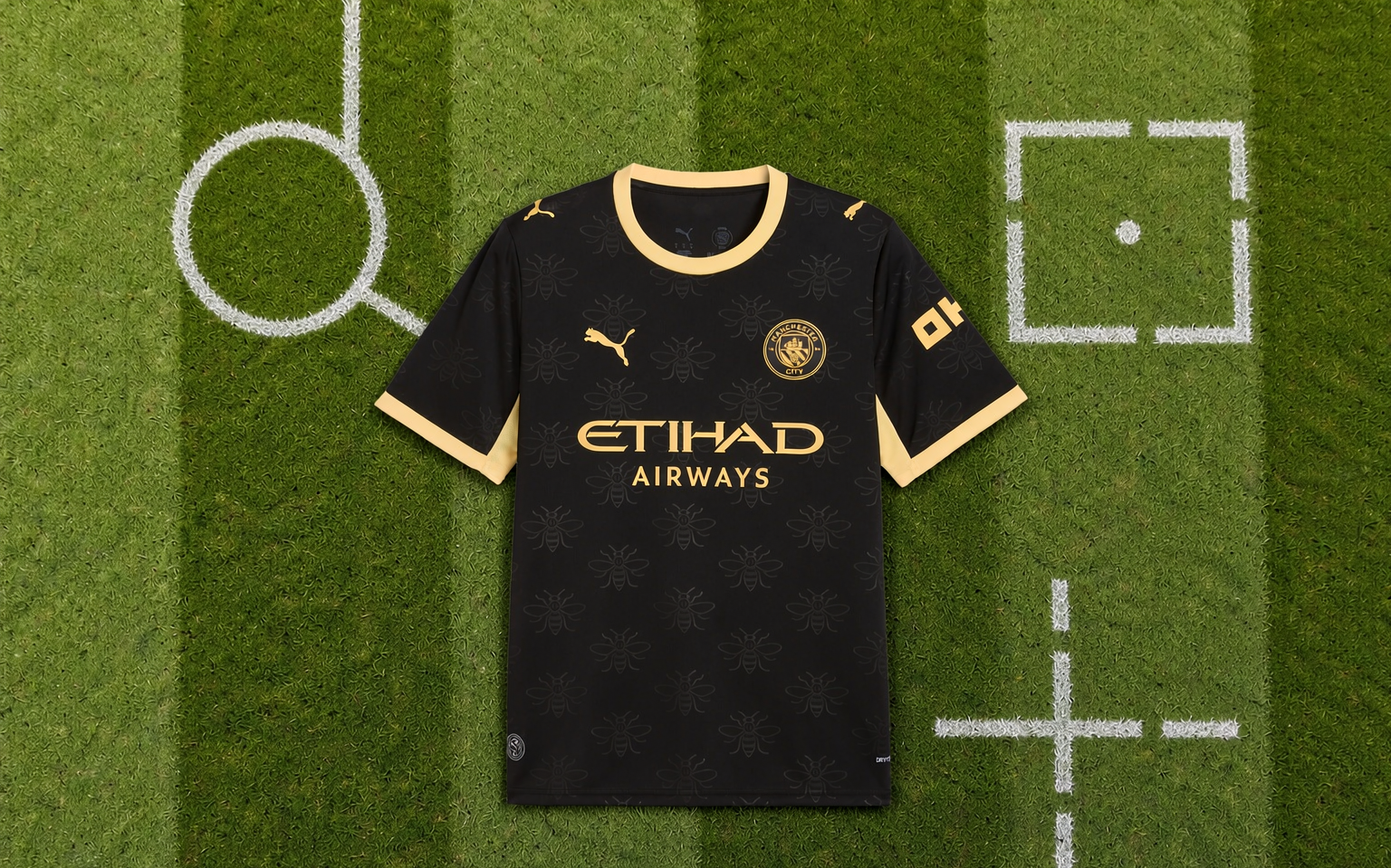Overhead view of a football shirt laid flat on mown grass inside a stadium