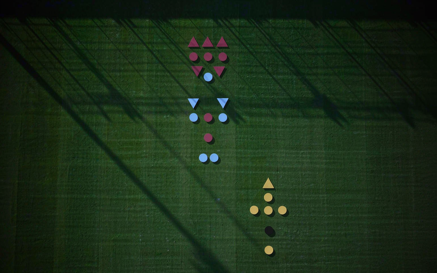 Overhead tactical view of two formations on a floodlit pitch