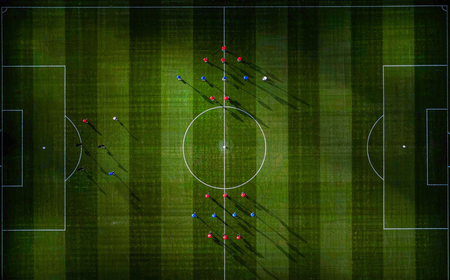 Top-down view of a pitch with 3-5-2 and 4-3-3 formation markers