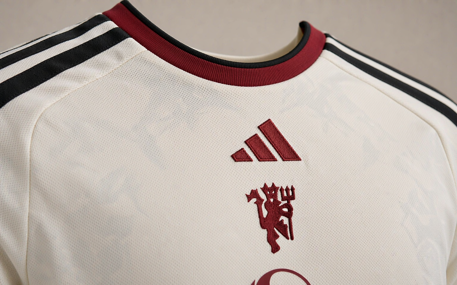 Close-up of football shirt fabric showing knit weave and collar stitching