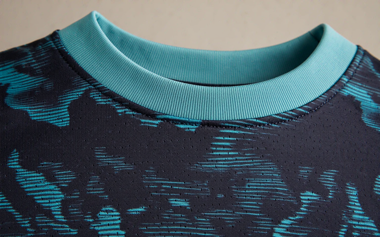 Close-up of football shirt fabric showing knit weave and collar stitching