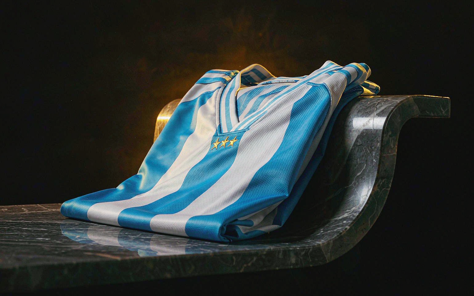 Argentina three-star jersey folded on dark stone