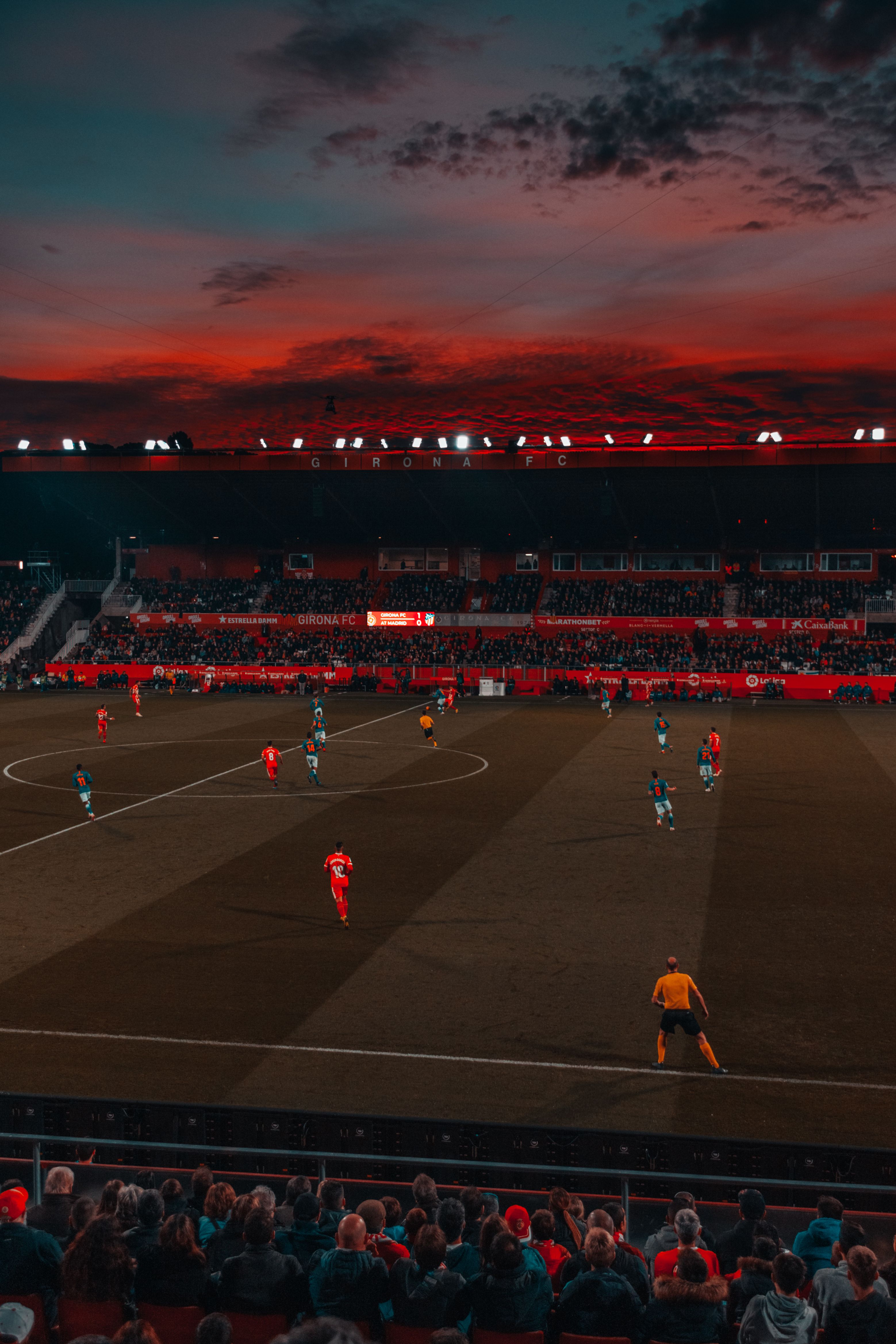 Soccer players preparing on the field at dusk as the new club season approaches