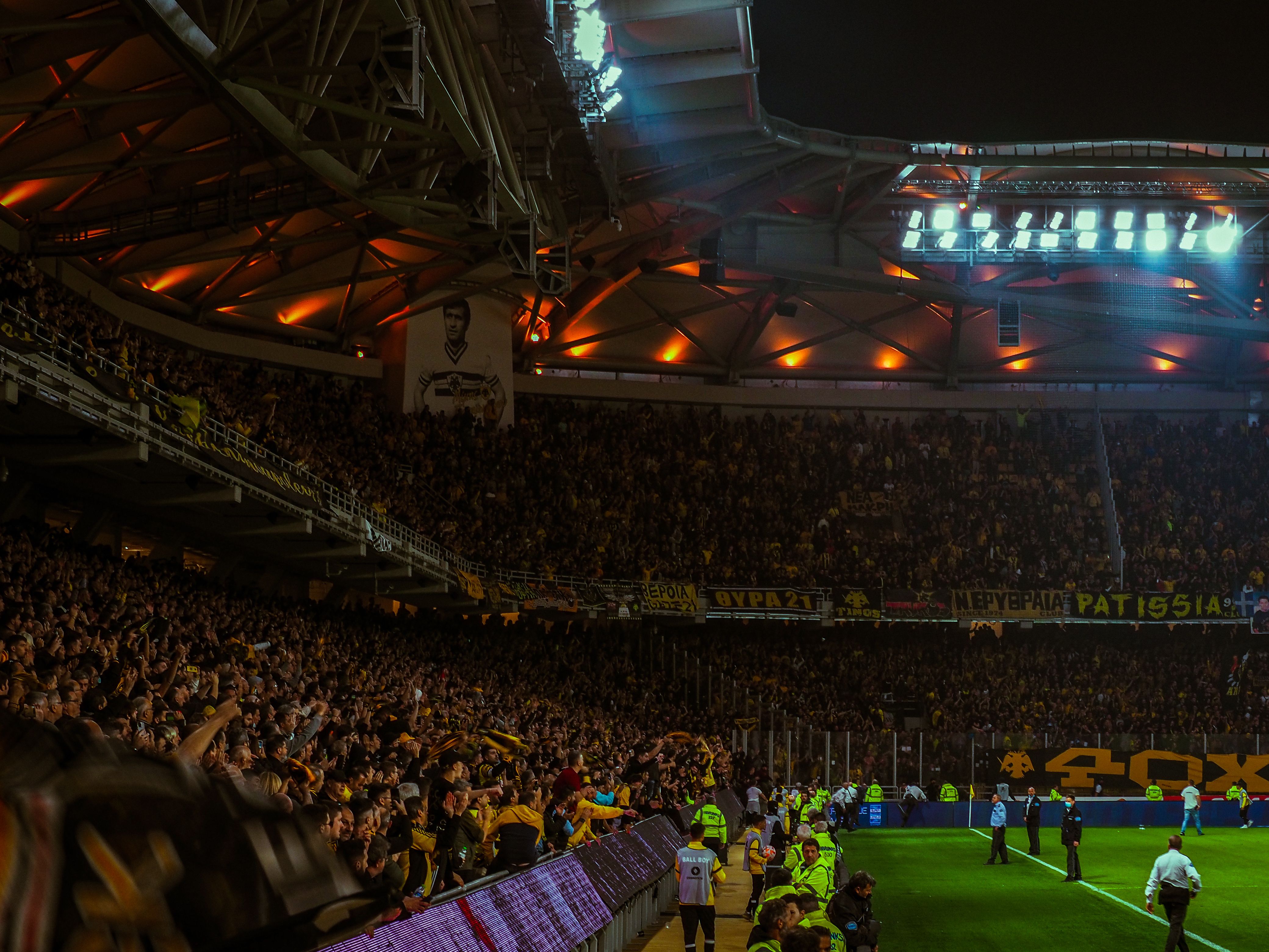 Football fans cheering in a packed stadium during a big match