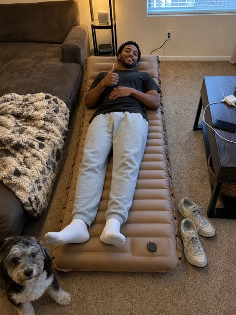 Customer-style snapshot of the camping mattress used as a guest bed