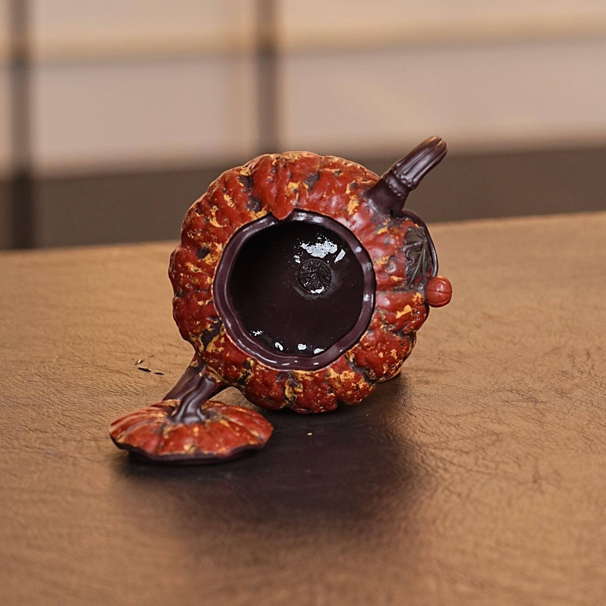 Fully handmade purple clay teapot featuring naturalistic pumpkin shape with distinct ridge lines dividing body sections by