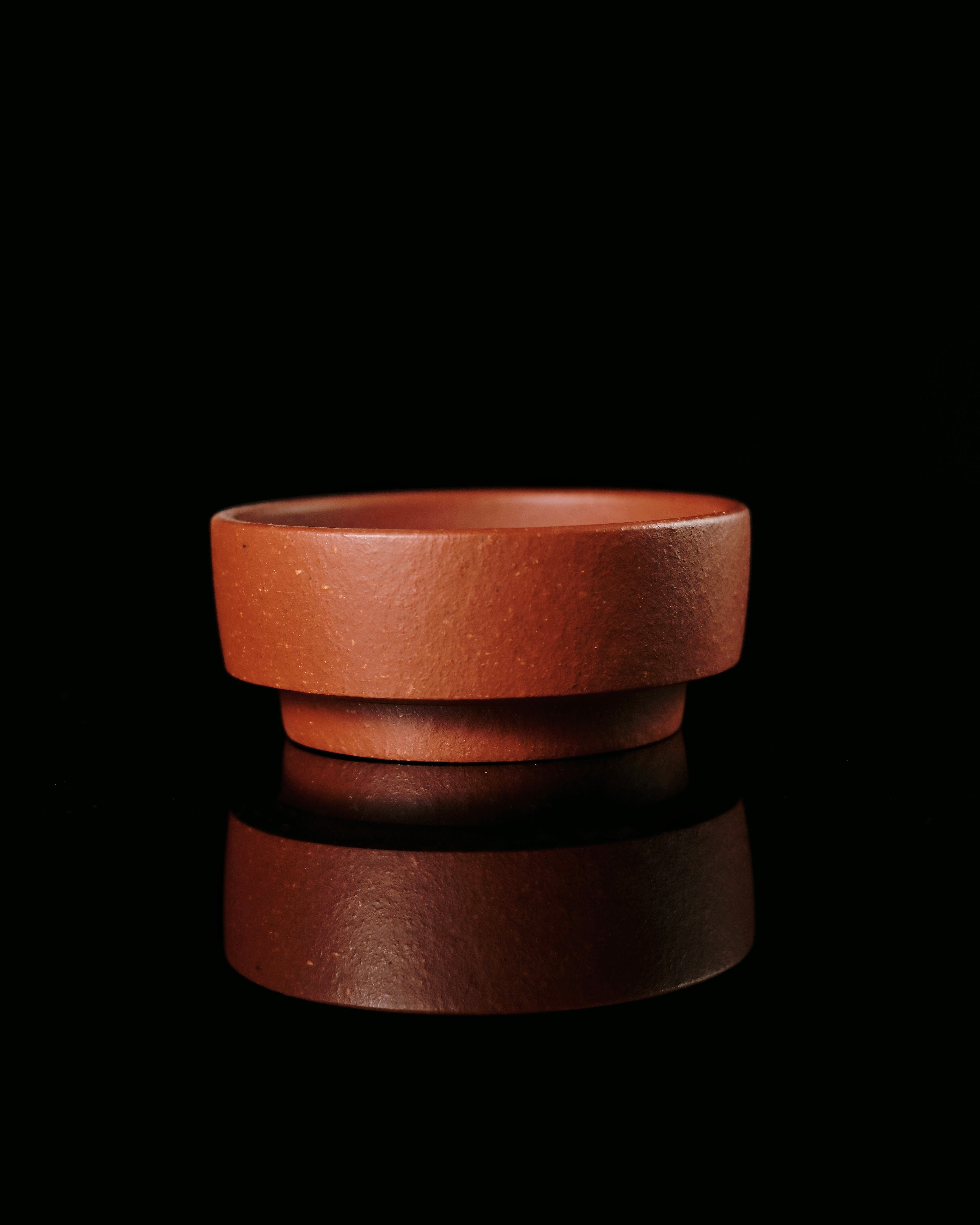 Mineral-rich Zisha clay with visible iron particles that create unique porous brewing properties by Kungfuyang