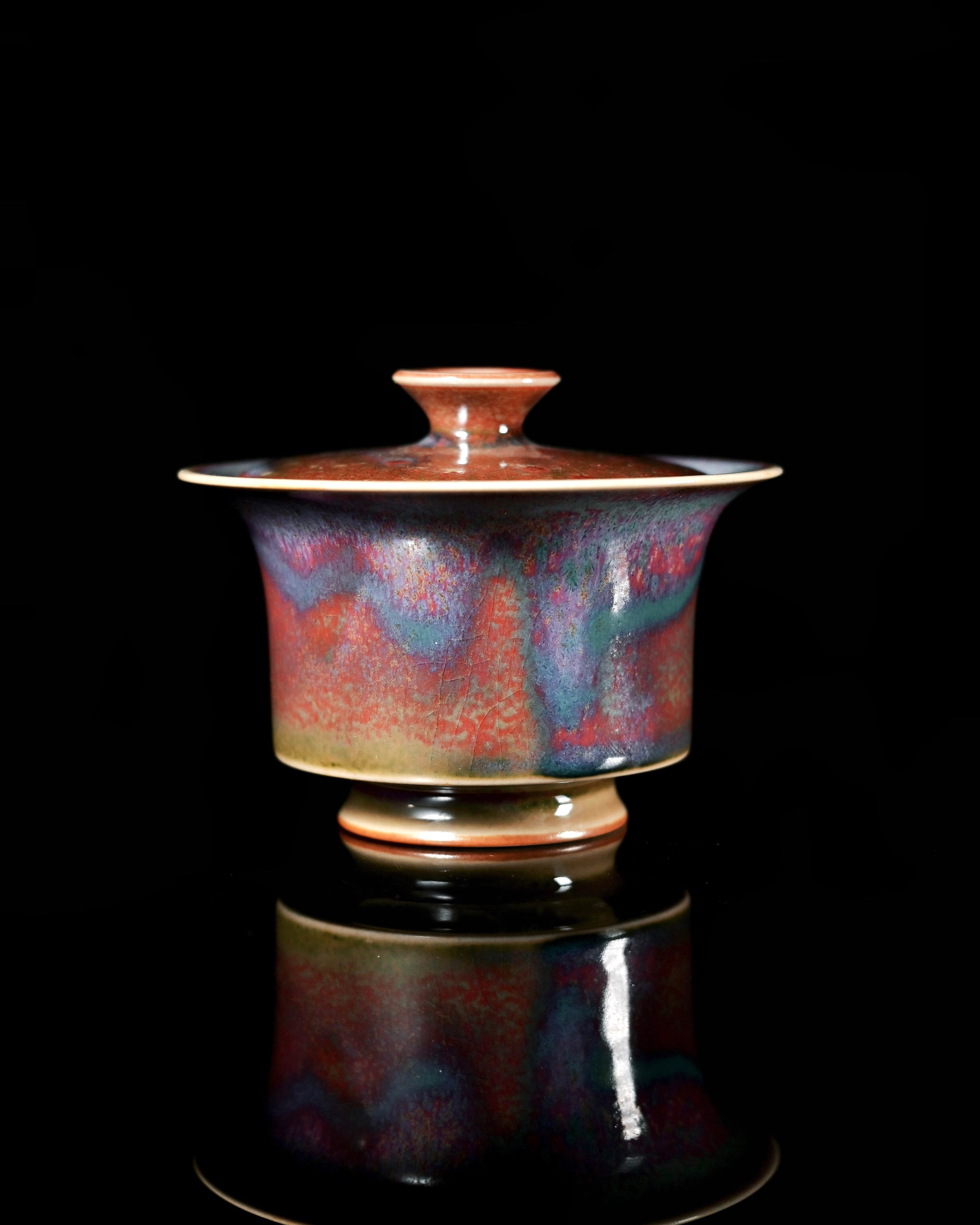 Copper-iron glaze flow patterns creating unique color variations through reduction firing by Kungfuyang