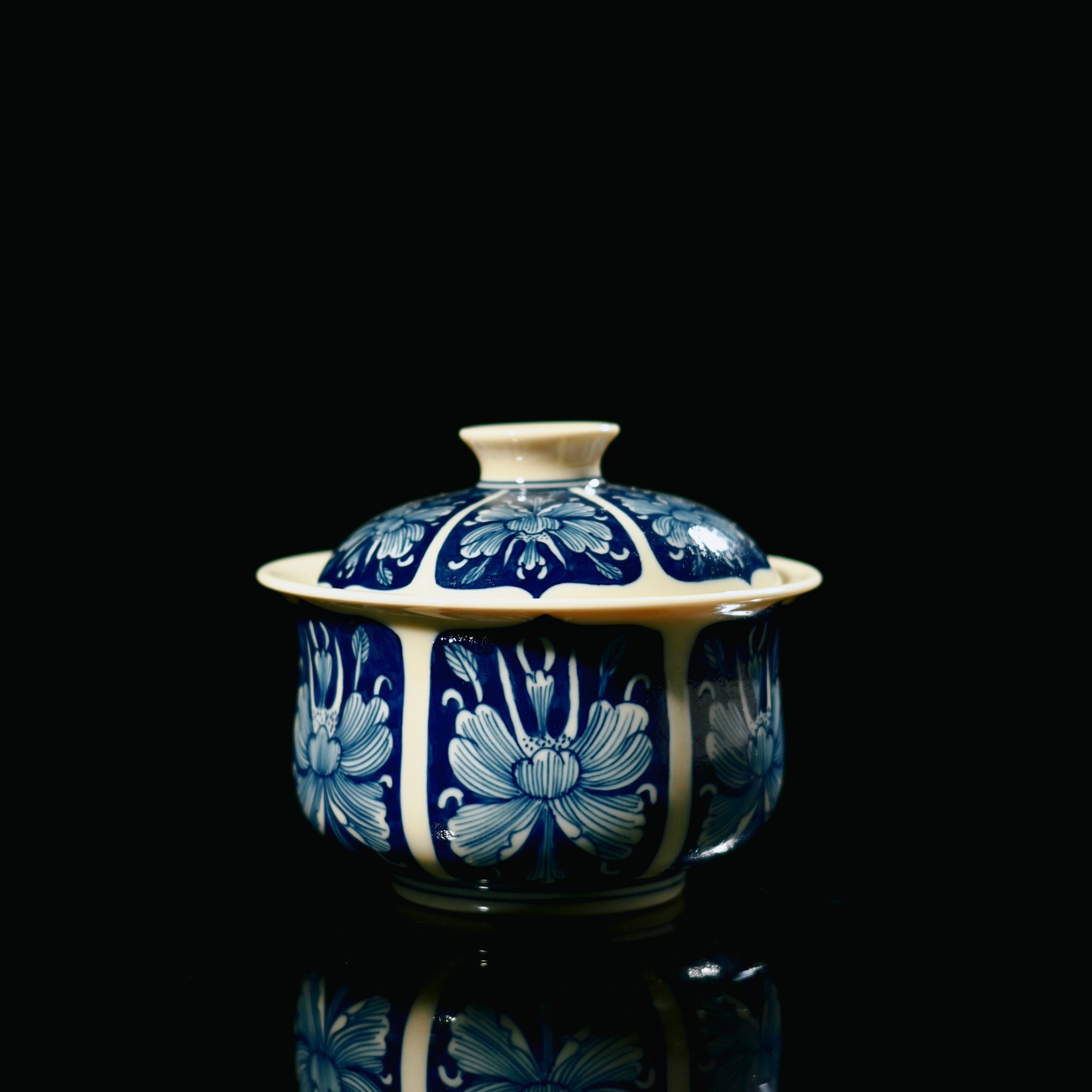 Jingdezhen antique-style gaiwan featuring blue ground decoration with white floral reserved areas by Kungfuyang