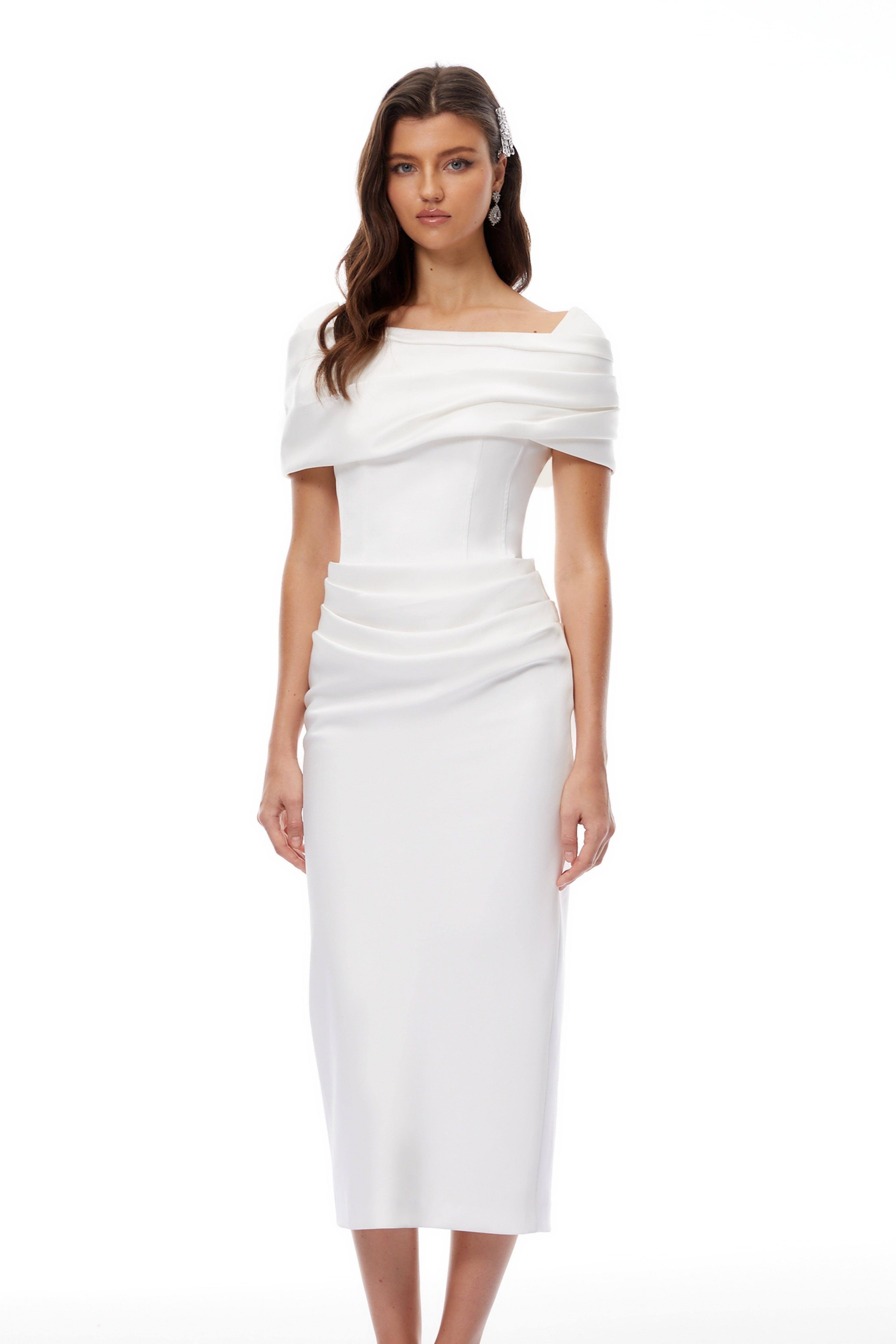 White off-the-shoulder gown with a draped bodice and cascading side ruffles