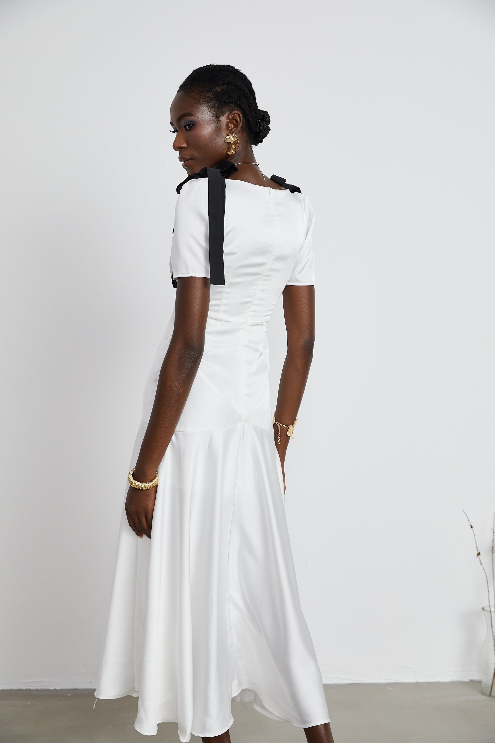 White satin V-neck midi dress with black bow shoulder straps