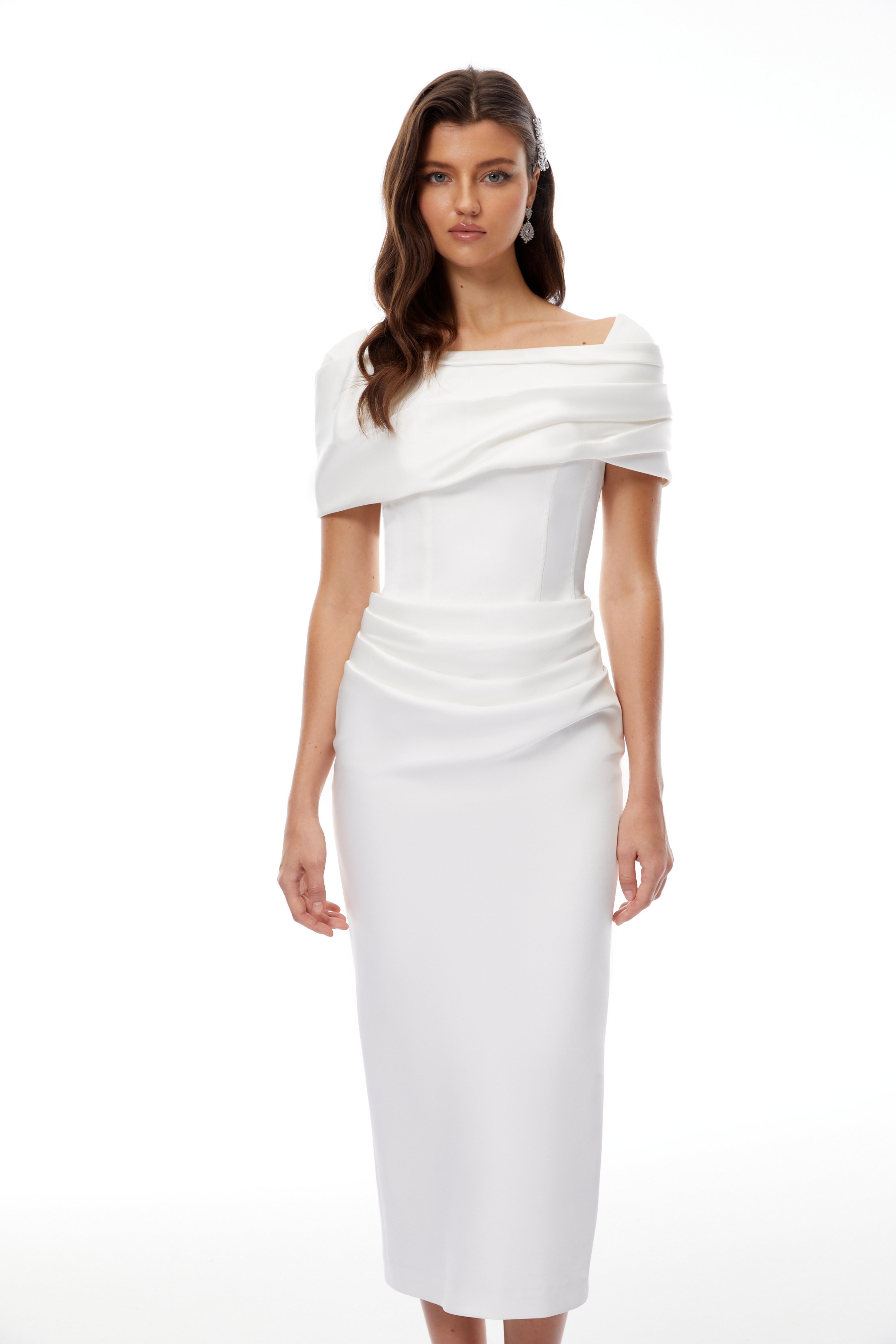 White off-the-shoulder gown with a draped bodice and cascading side ruffles