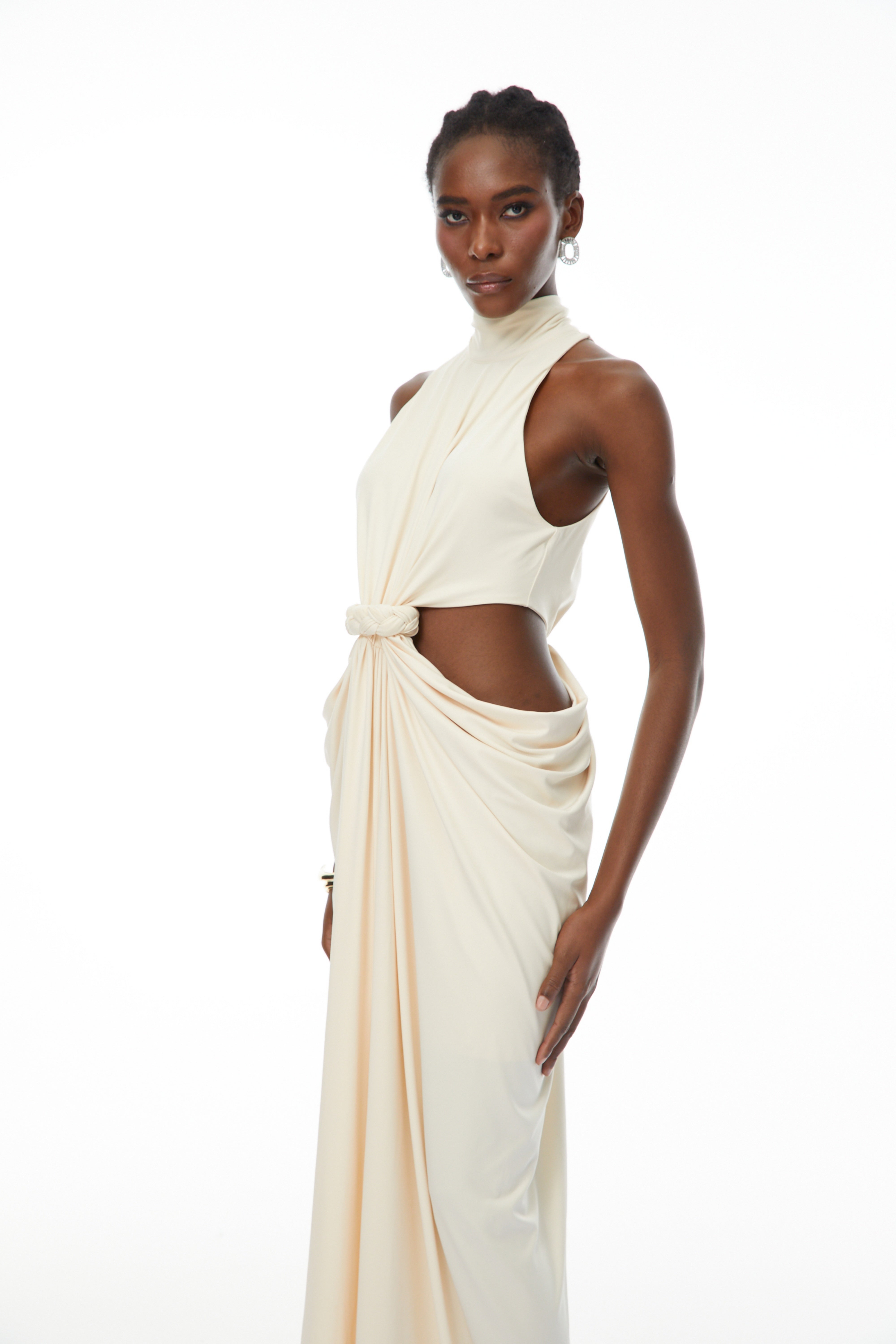 Cream halter maxi dress with waist cutouts and a knotted draped bodice