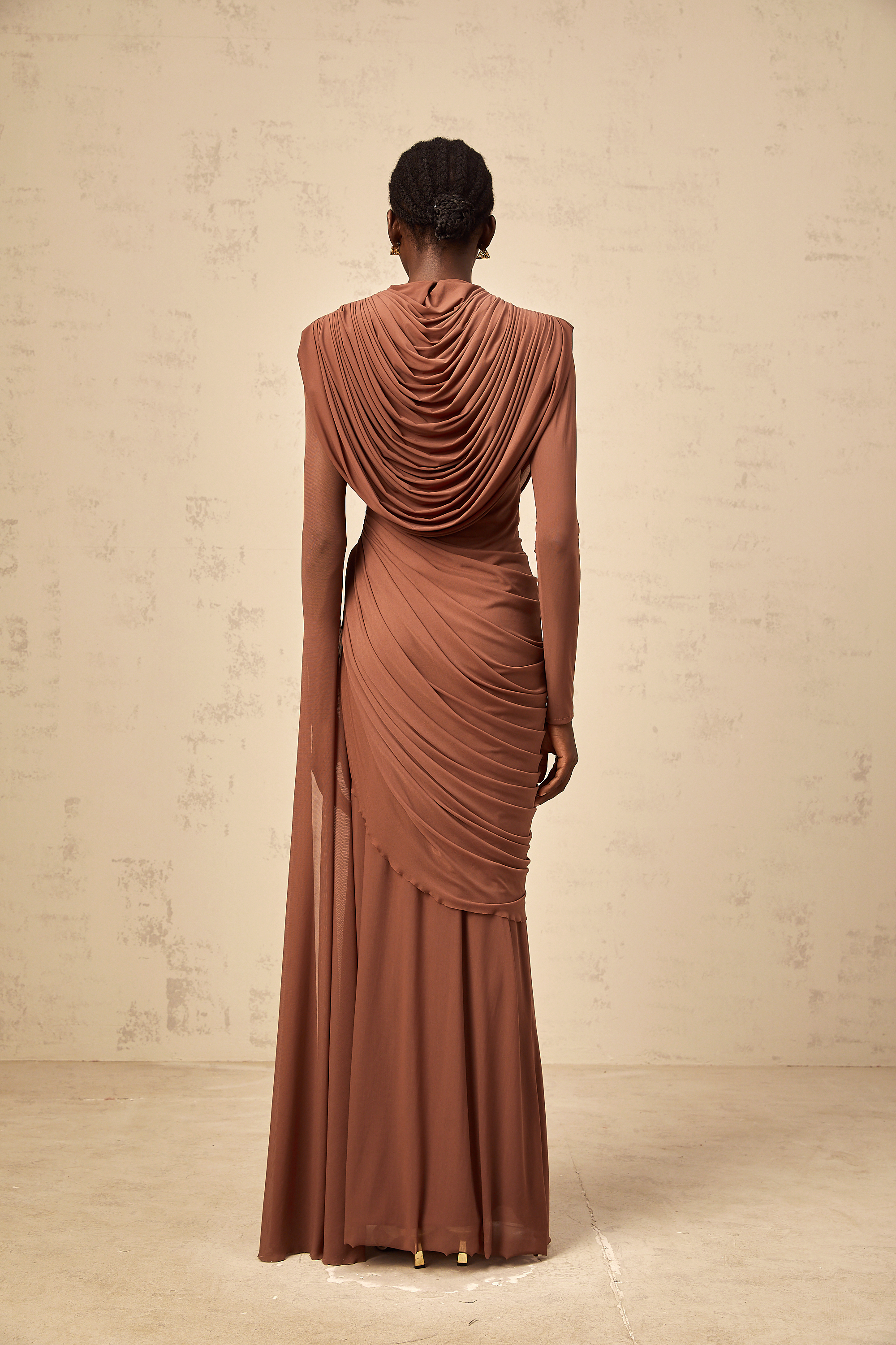 Rust-colored long-sleeve maxi dress with a draped cowl neckline and pleated bodice