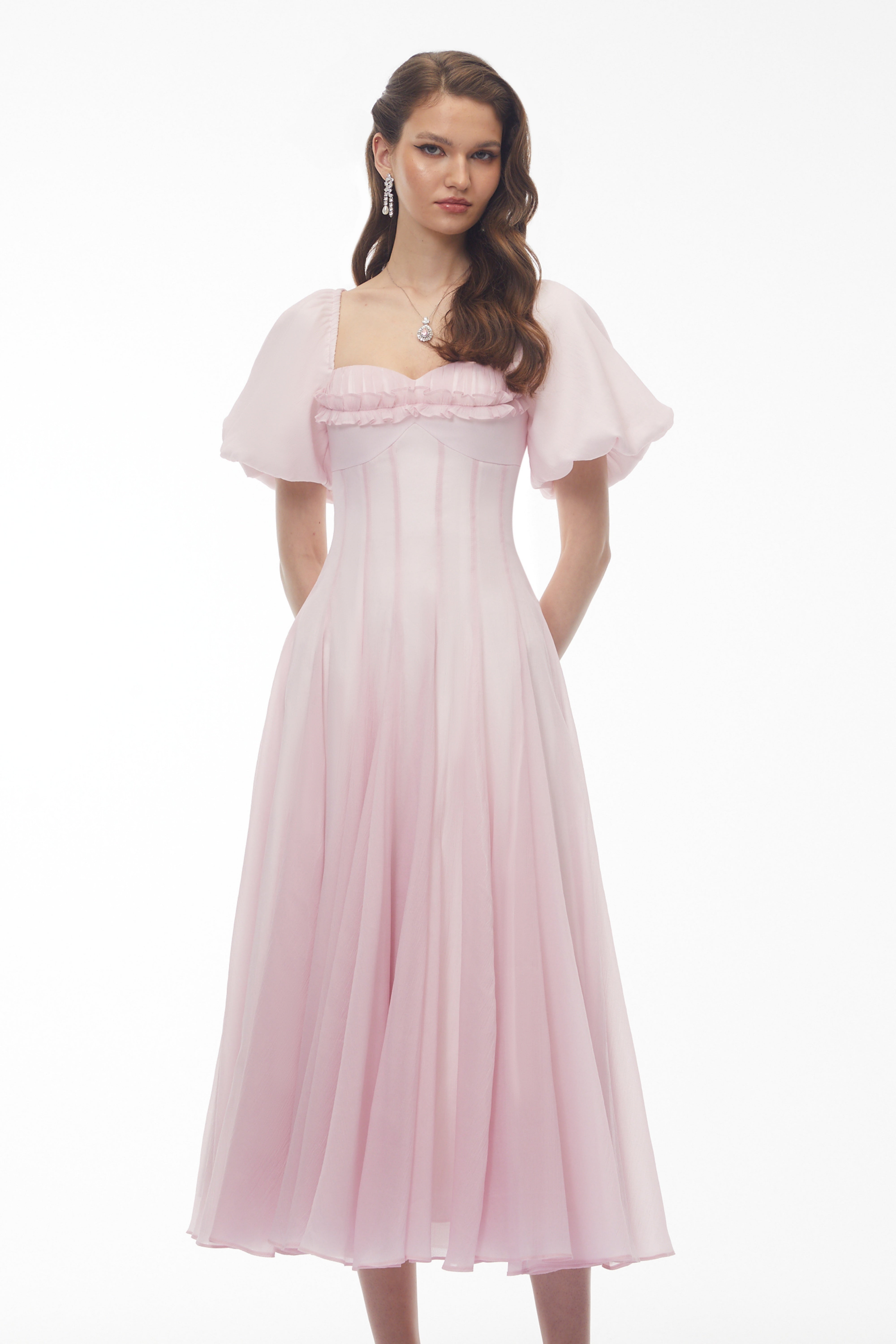 Light pink midi dress with puff sleeves, a ruffled sweetheart neckline, and a pleated skirt