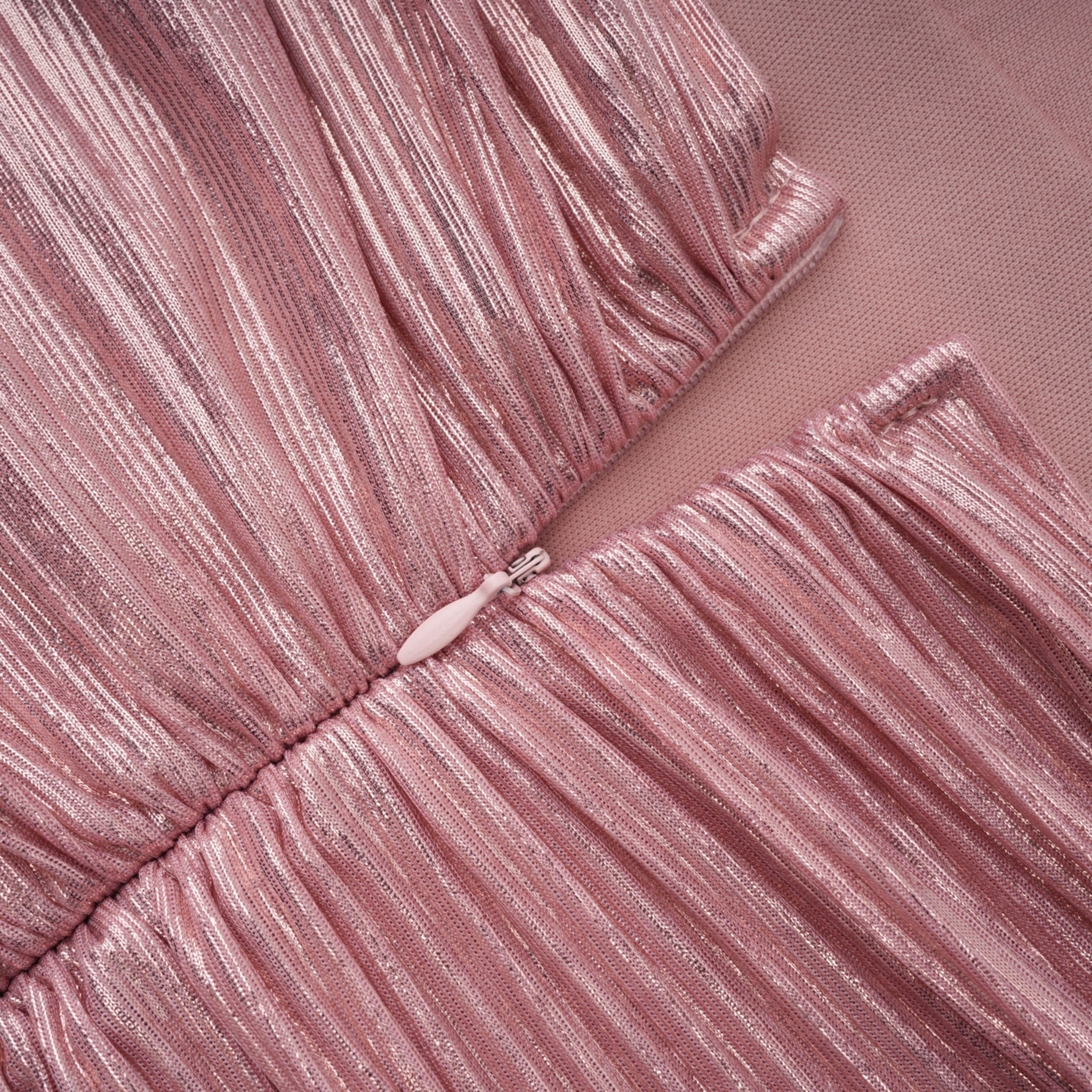 Metallic rose pink pleat halter gown with a cinched waist and high leg slit