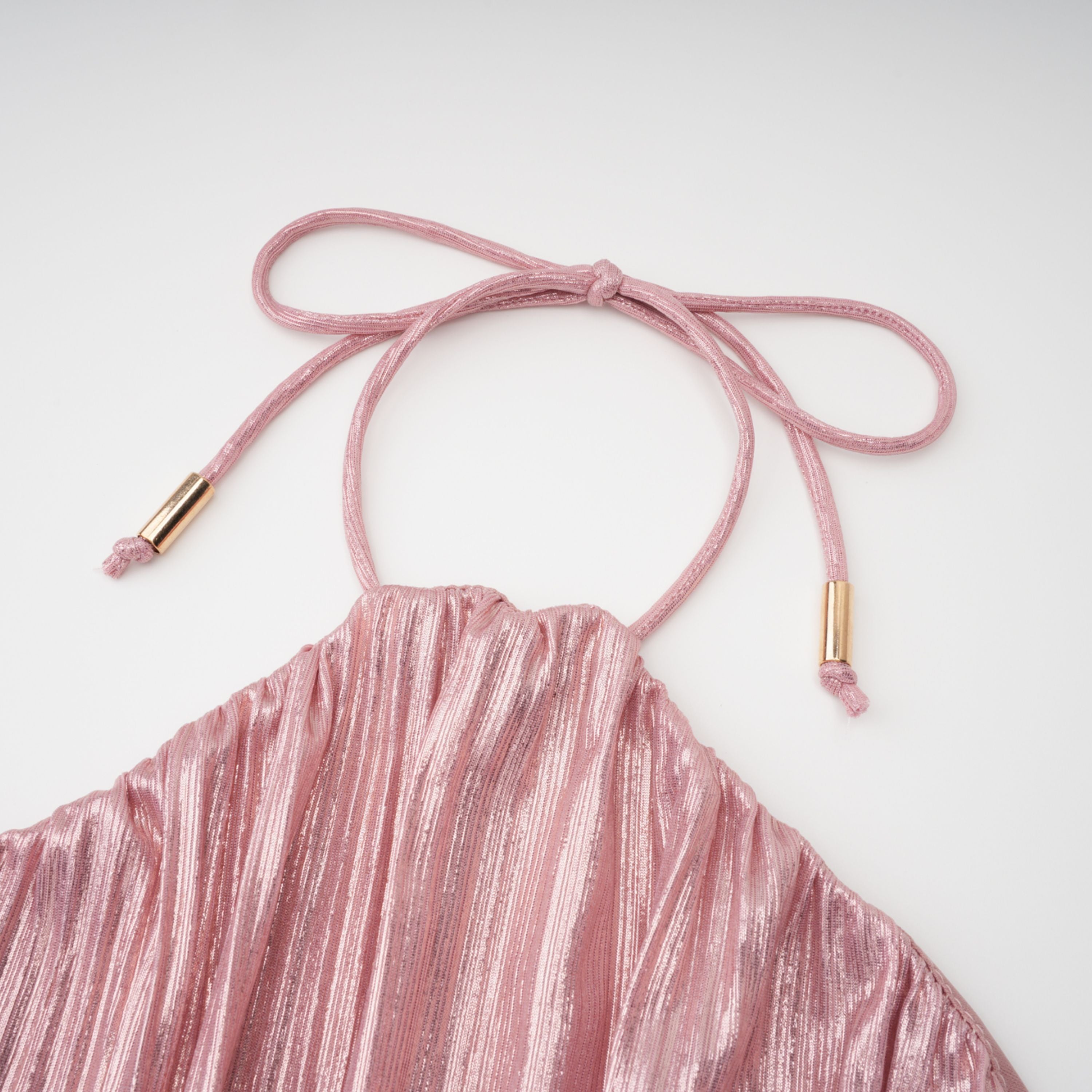 Metallic rose pink pleat halter gown with a cinched waist and high leg slit