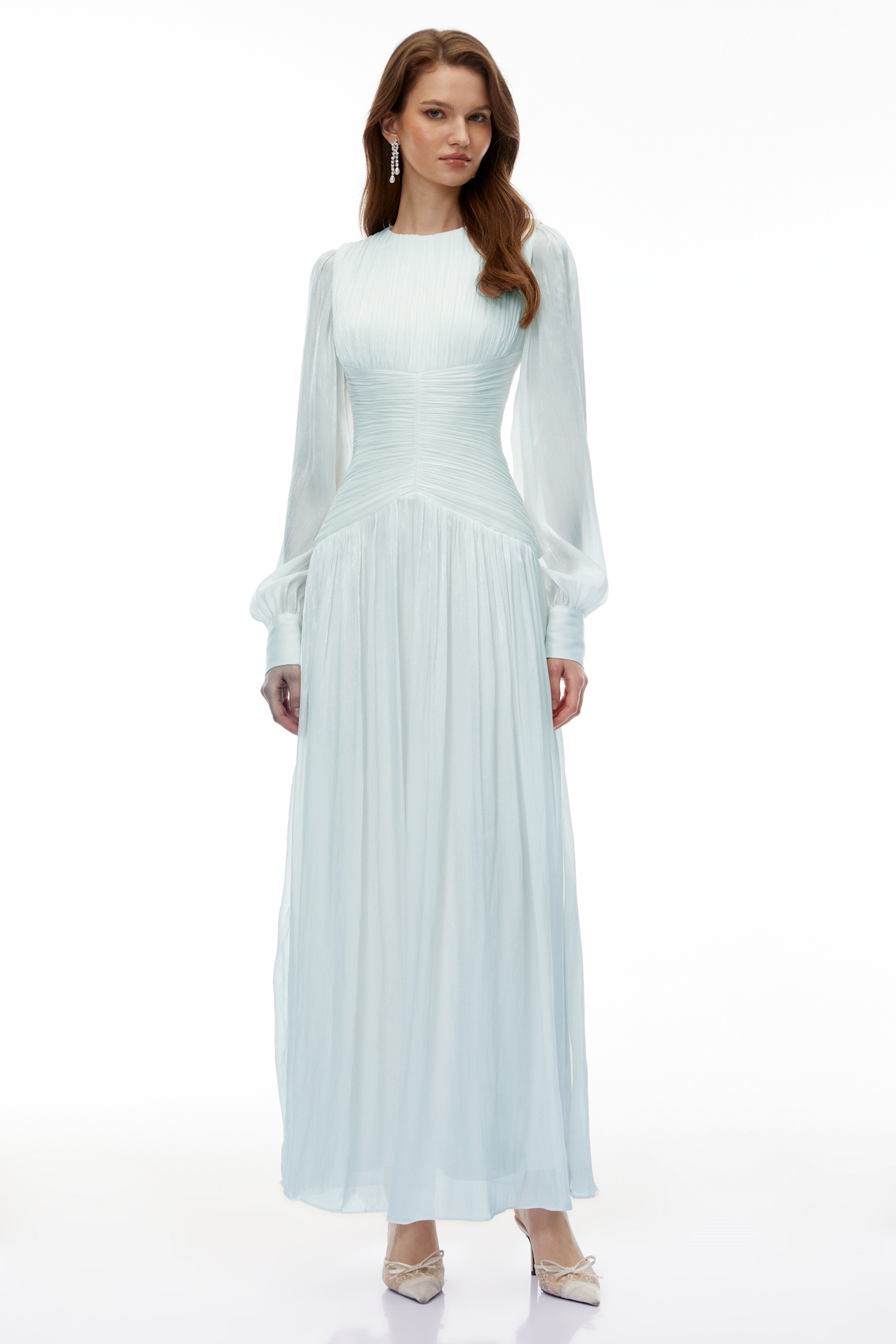 Light green maxi dress with a ruched bodice, round neckline, and long sheer sleeves