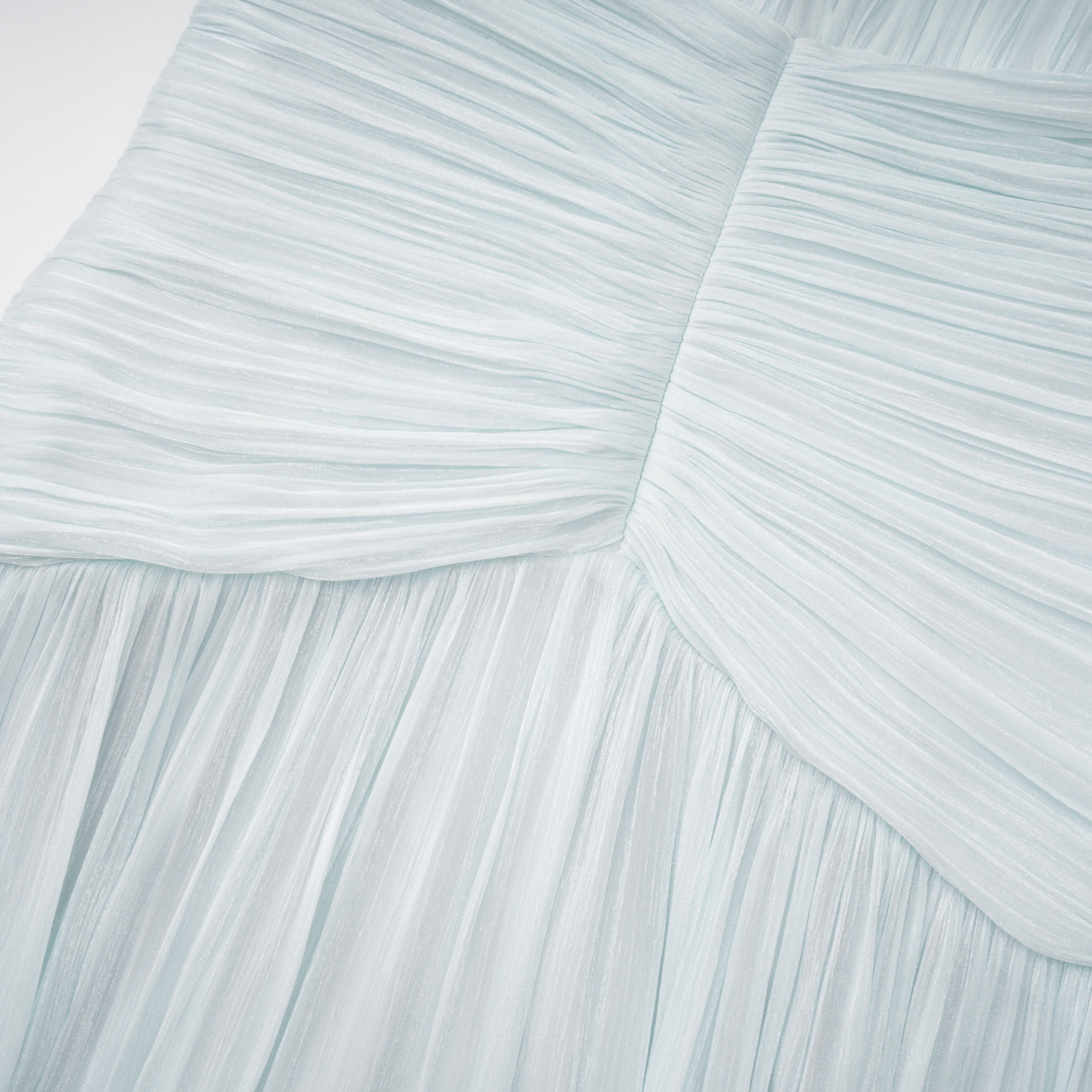 Light green maxi dress with a ruched bodice, round neckline, and long sheer sleeves