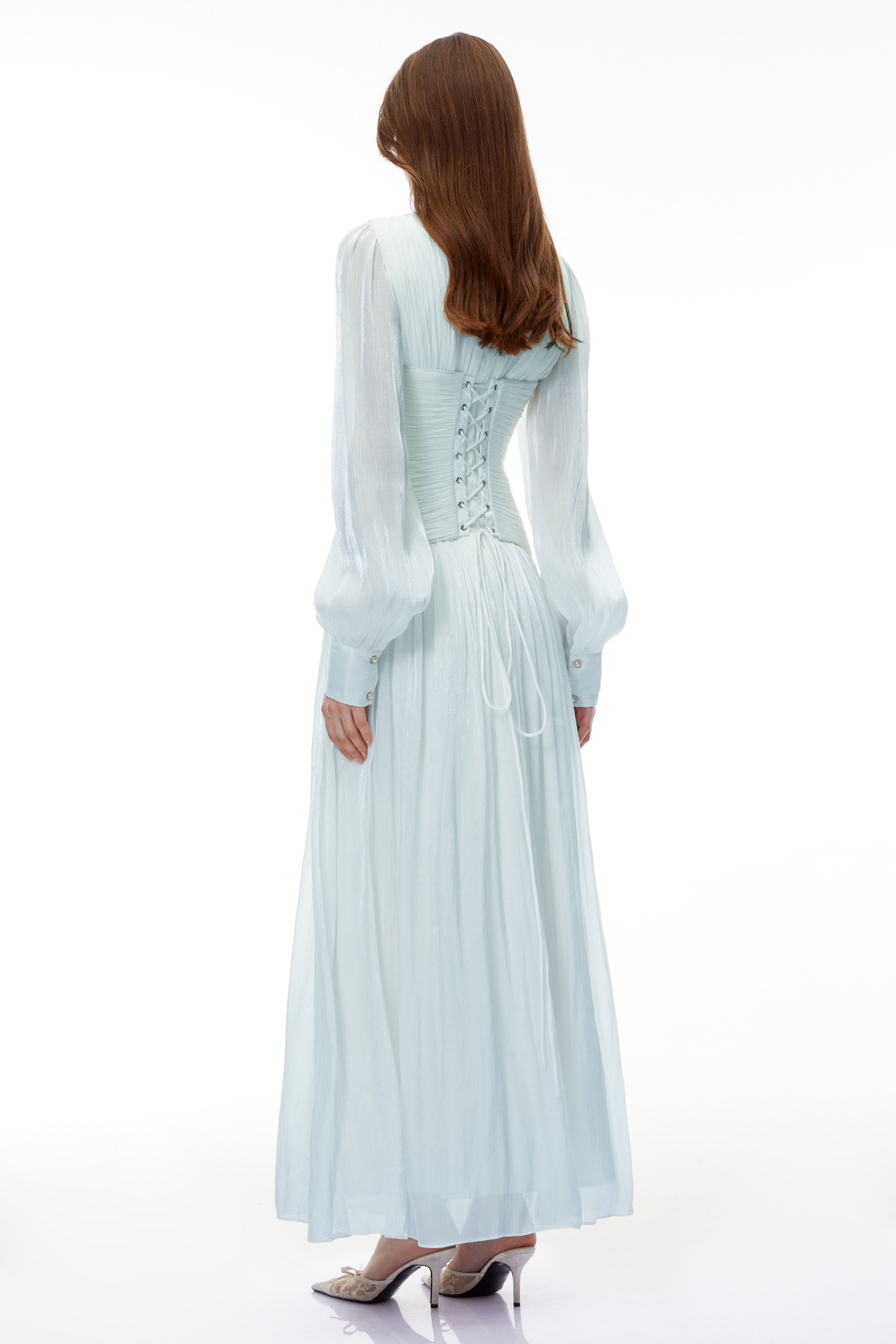 Light green maxi dress with a ruched bodice, round neckline, and long sheer sleeves