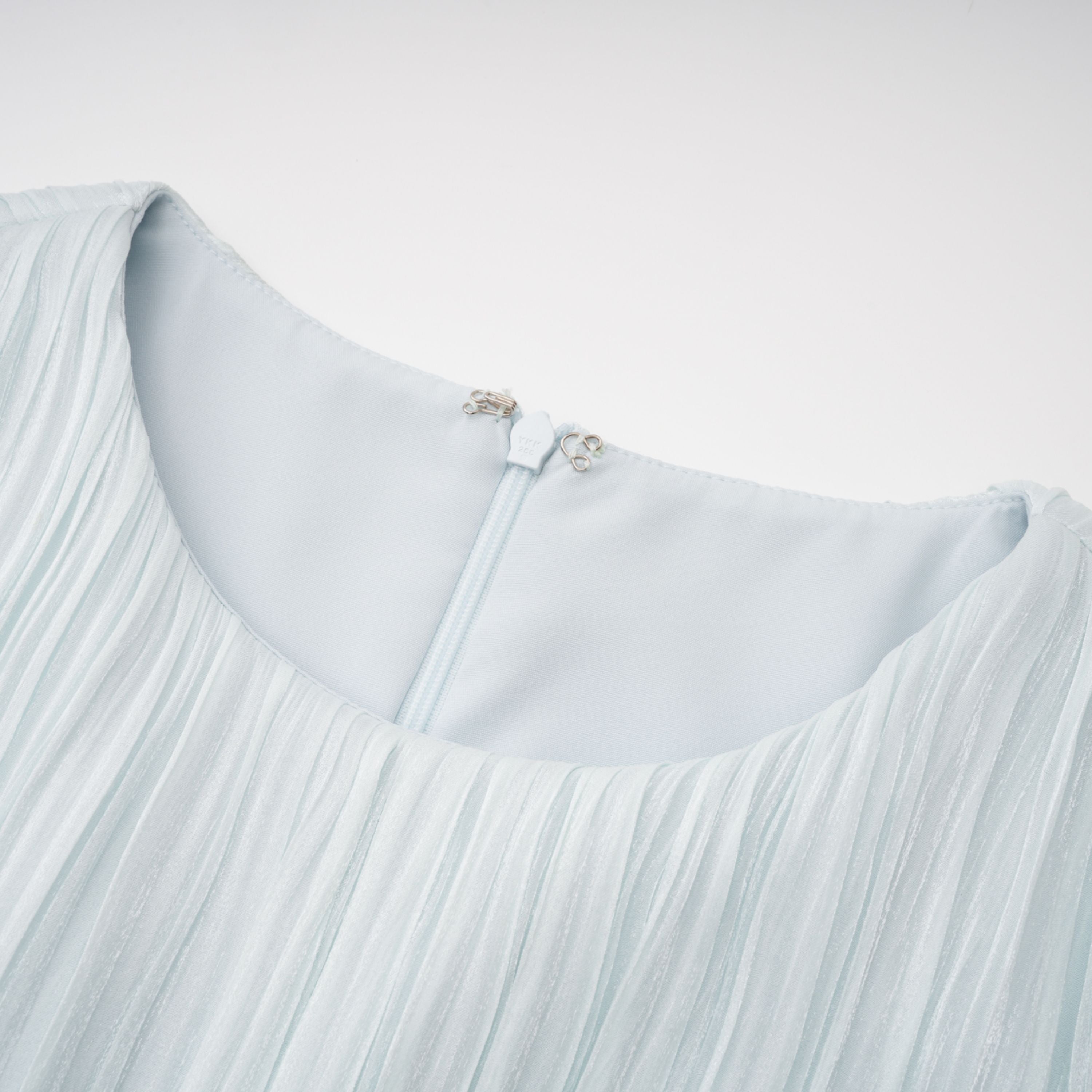 Light green maxi dress with a ruched bodice, round neckline, and long sheer sleeves