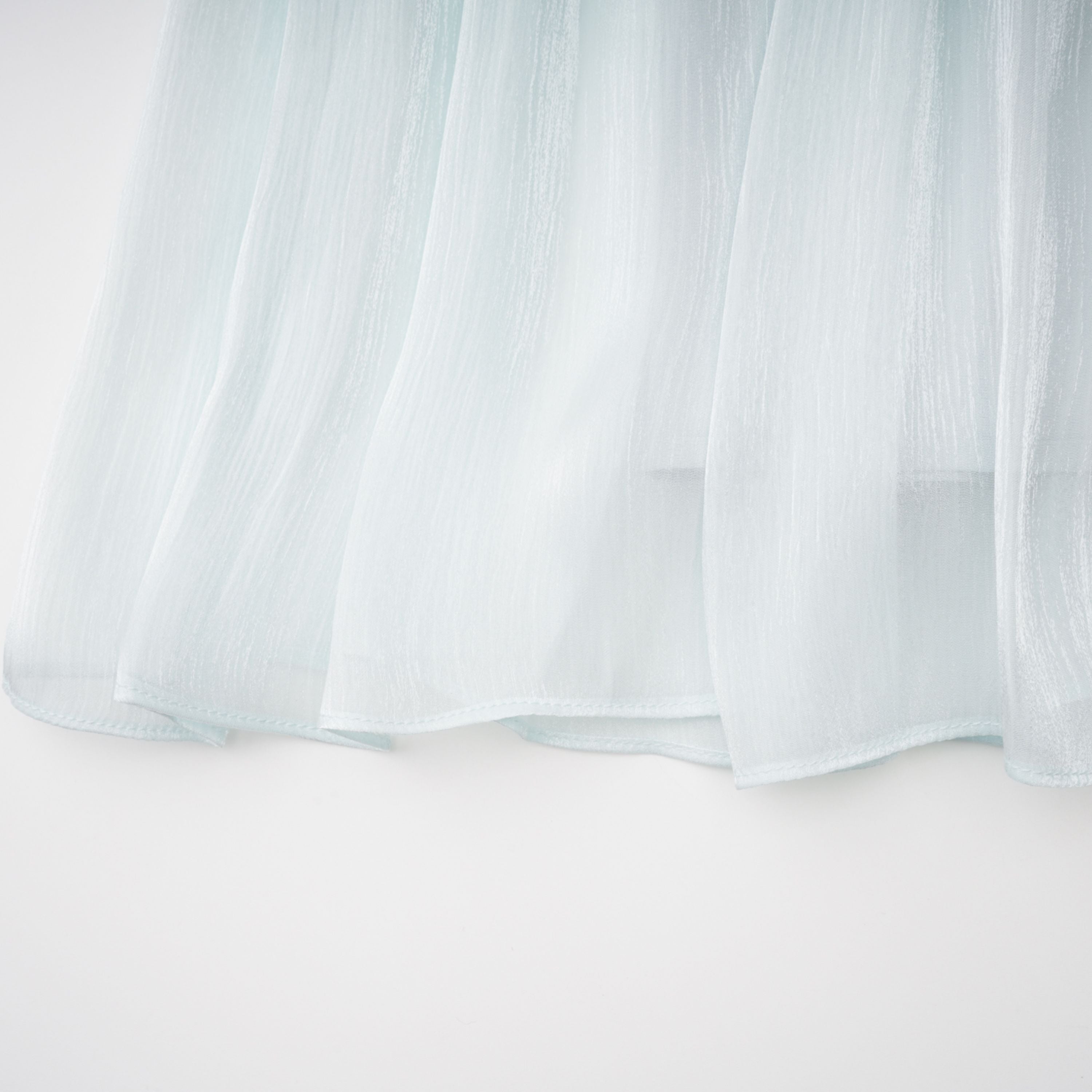 Light green maxi dress with a ruched bodice, round neckline, and long sheer sleeves