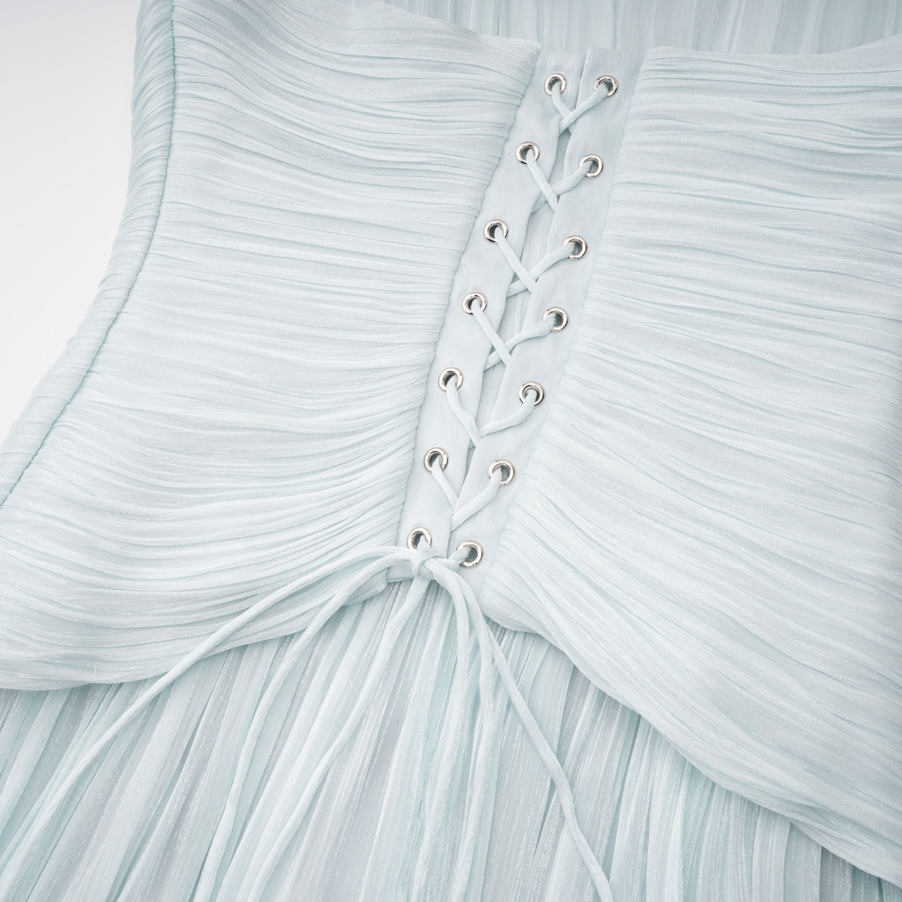 Light green maxi dress with a ruched bodice, round neckline, and long sheer sleeves