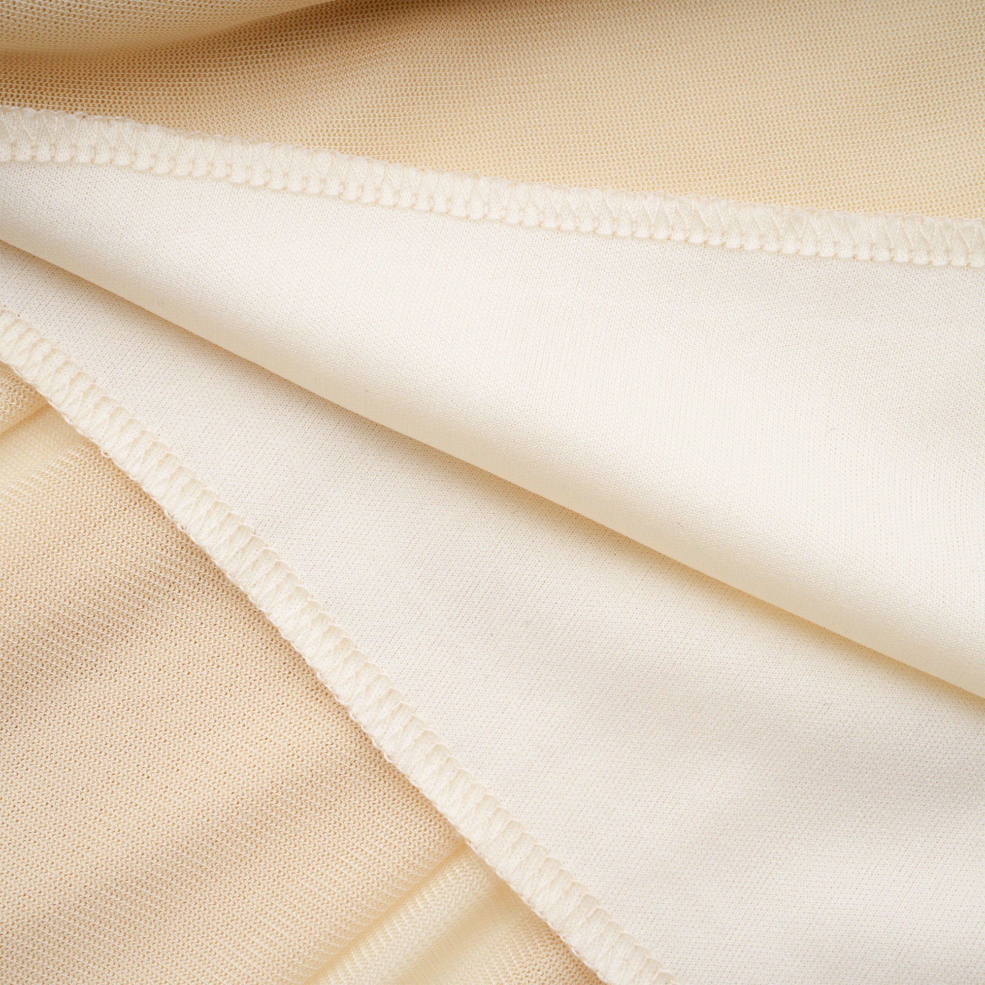 Pale yellow maxi dress with a ruched bodice, high round neckline, and long bishop sleeves