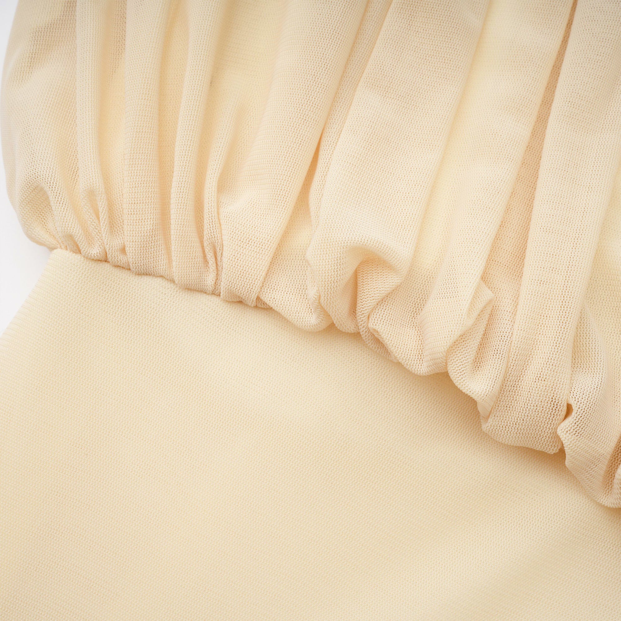 Pale yellow maxi dress with a ruched bodice, high round neckline, and long bishop sleeves