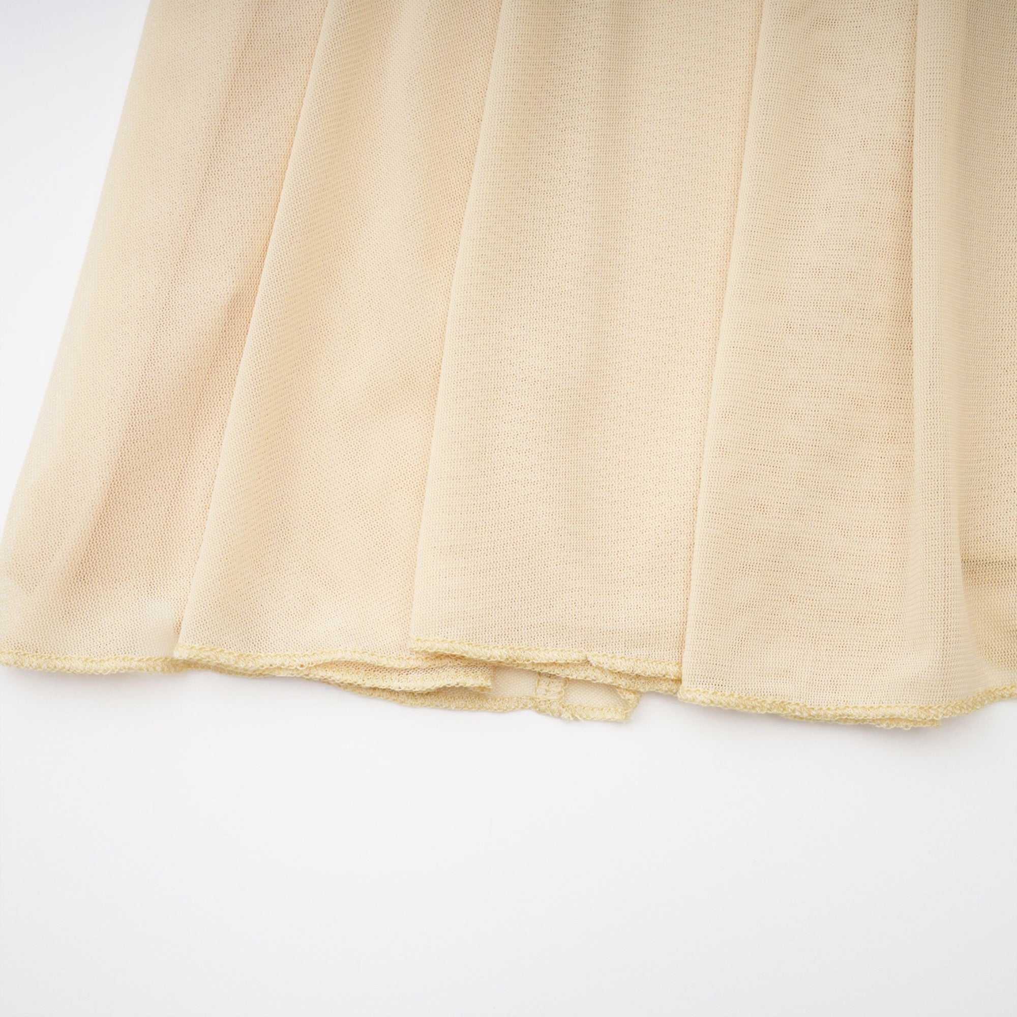 Pale yellow maxi dress with a ruched bodice, high round neckline, and long bishop sleeves