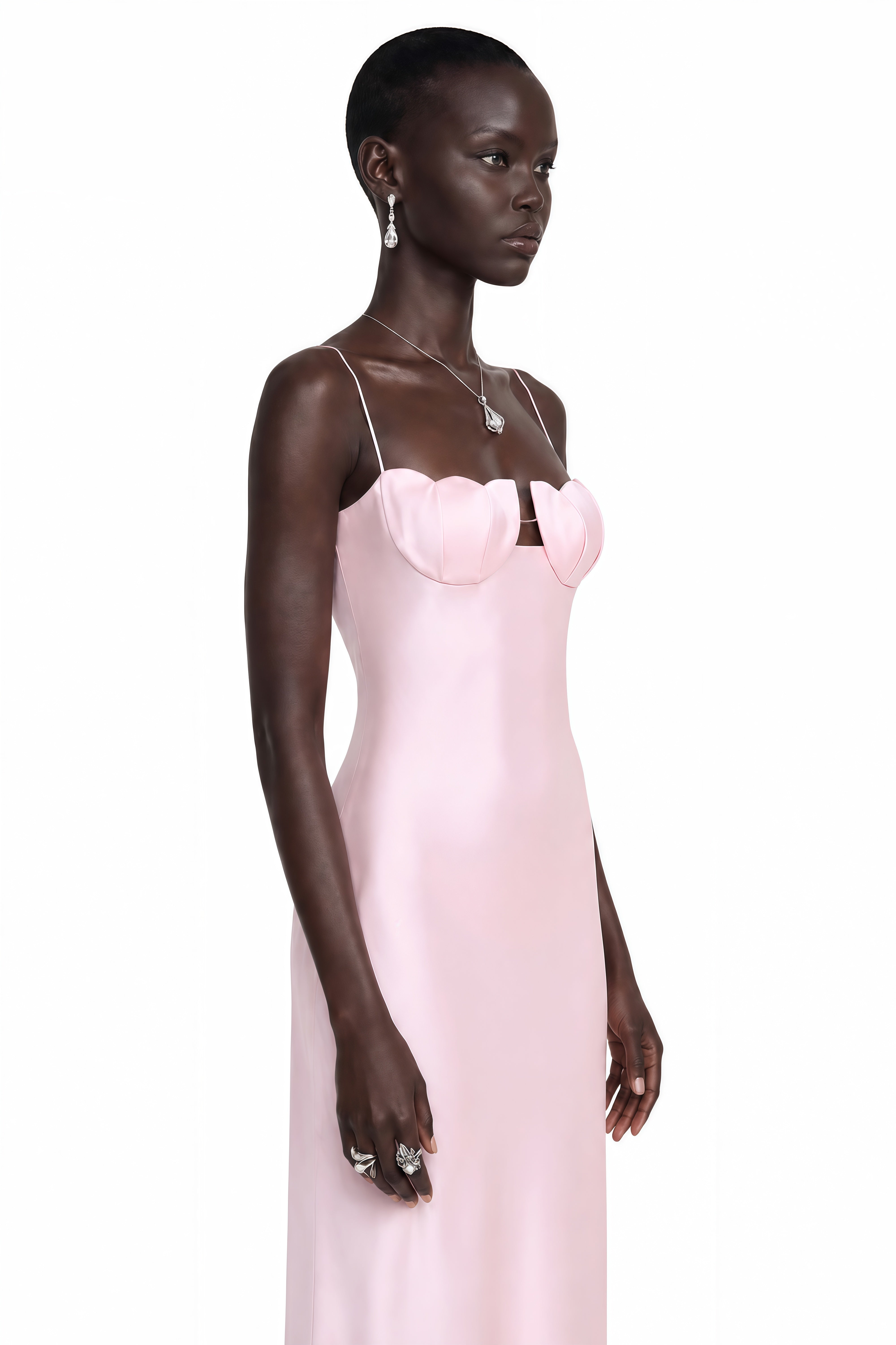 Pink satin slip maxi dress featuring a sculpted seashell-style bustier and thin spaghetti straps