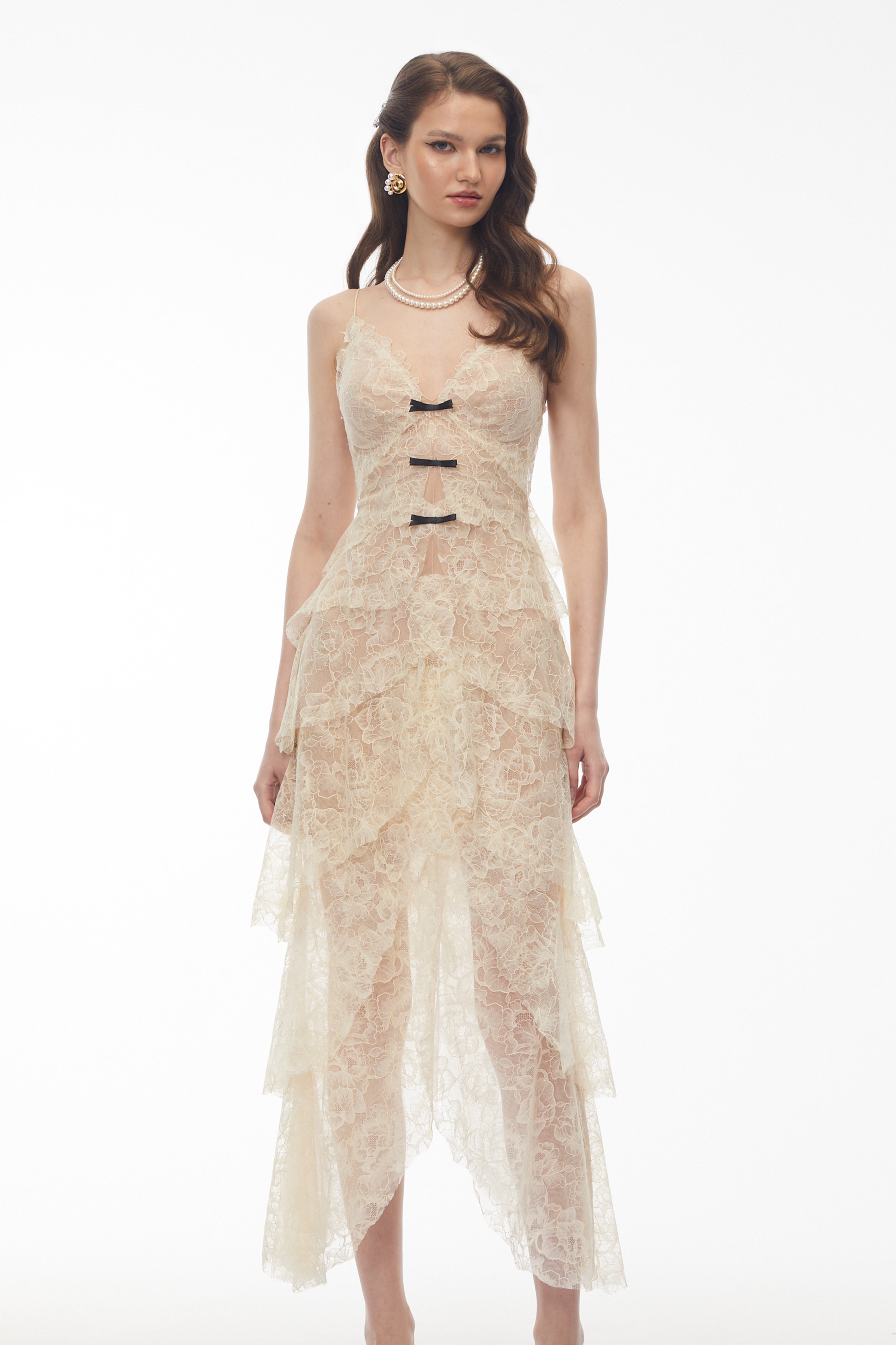Cream tiered lace maxi dress with small black bow accents