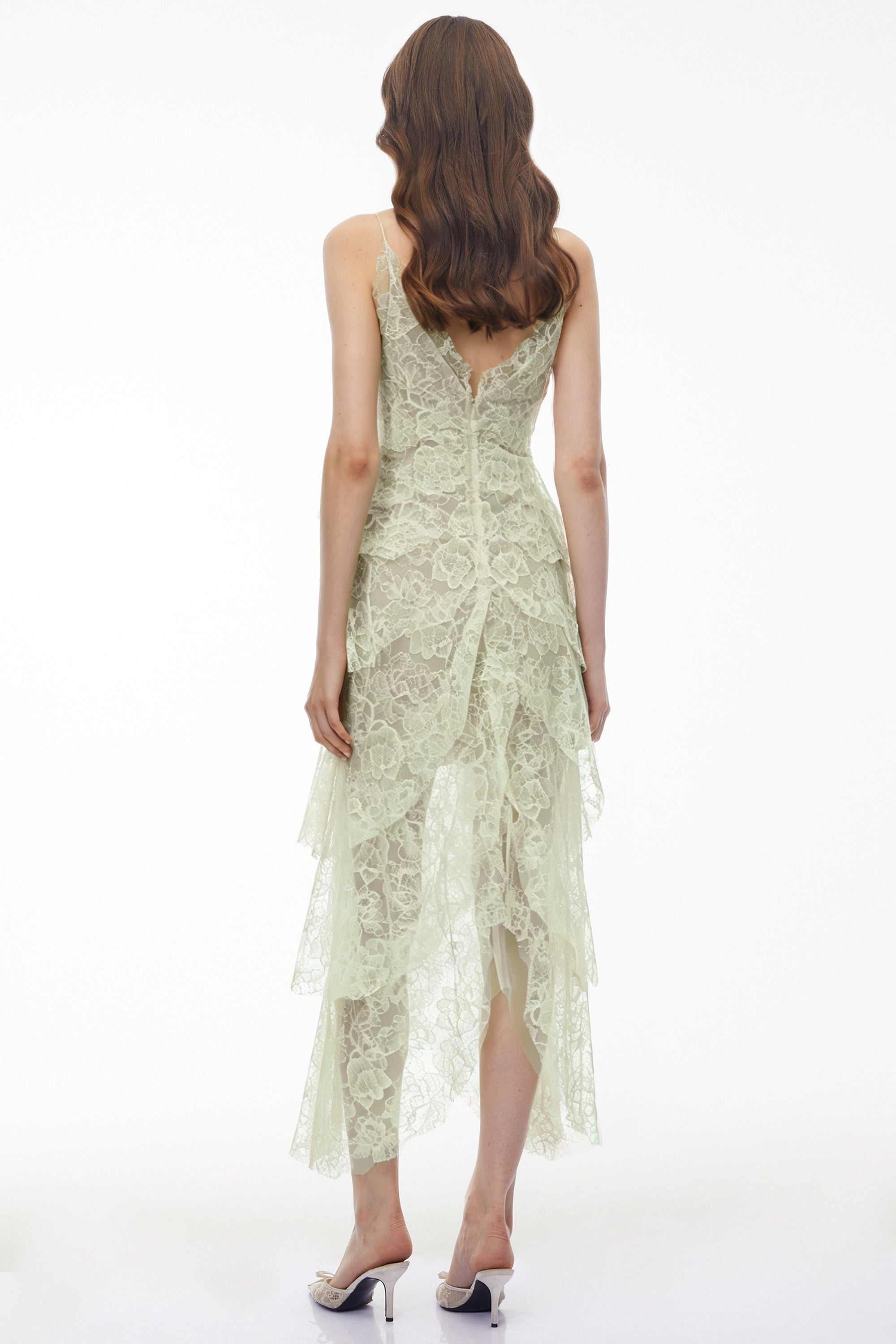 Sage green tiered lace dress with black bow accents