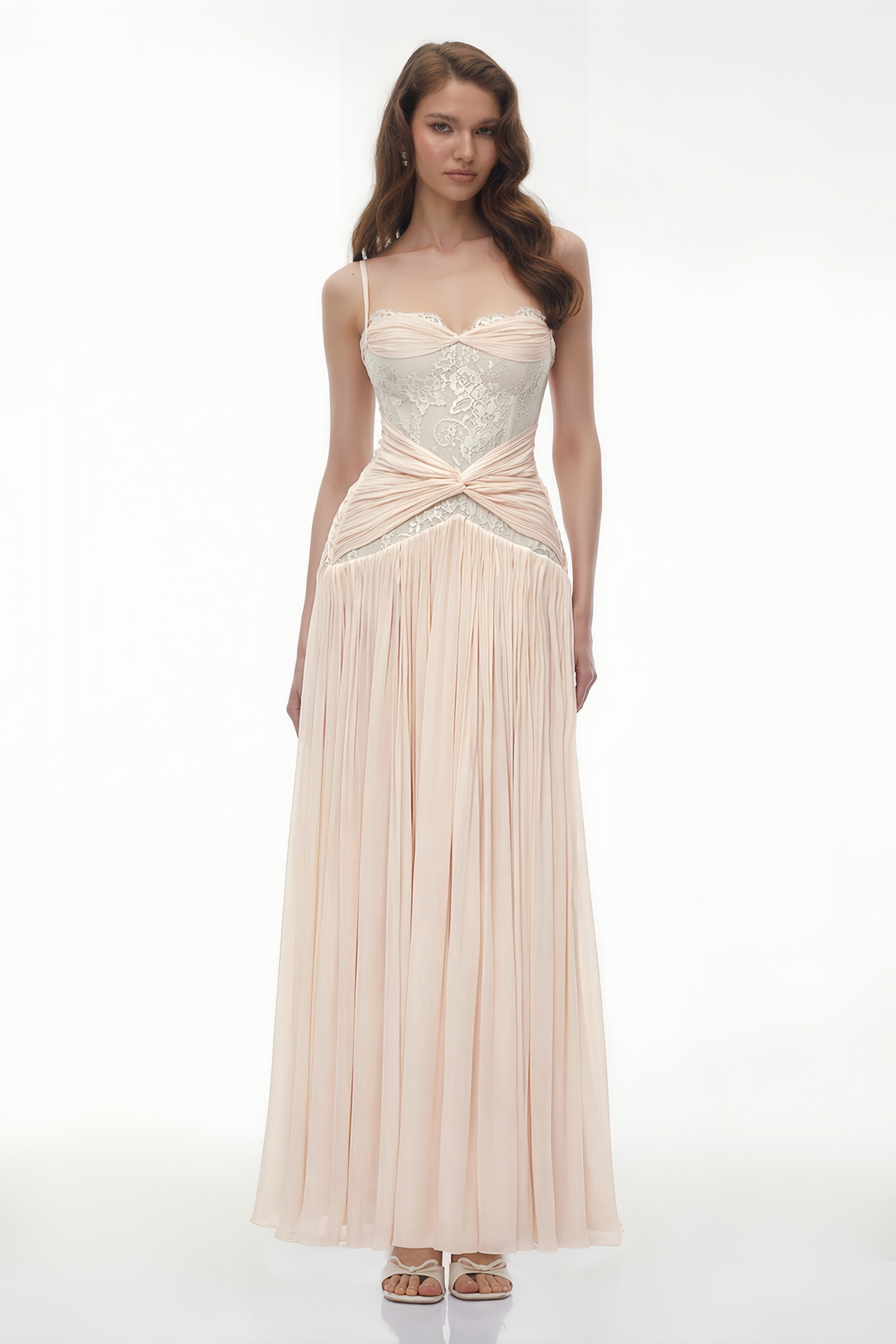 Light pink maxi dress featuring a sheer white lace corset bodice, a draped twist waistband, and a finely pleated skirt
